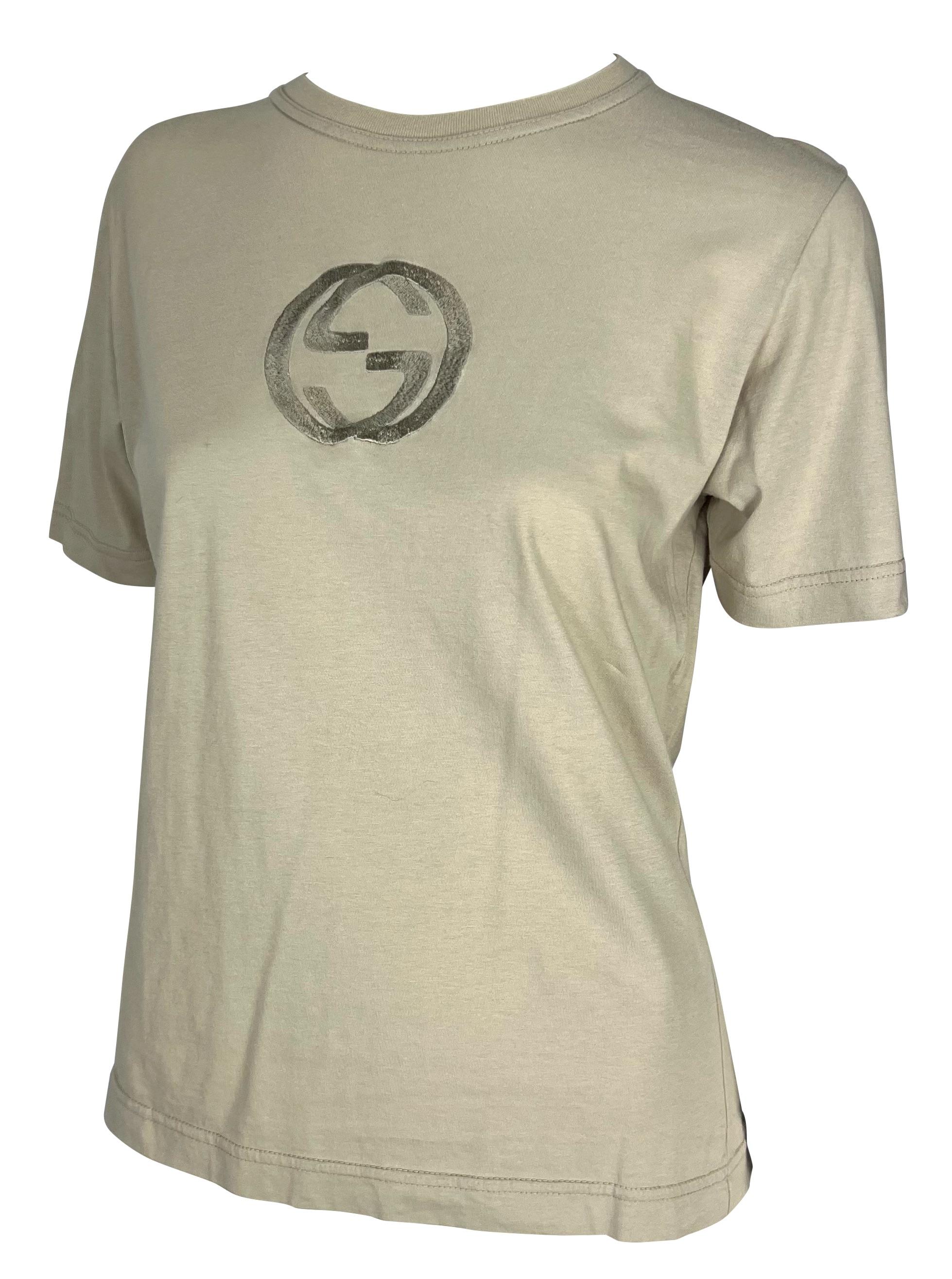 Presenting a taupe branded Gucci t-shirt, designed by Tom Ford. From the Spring/Summer 1997 collection, this classic crewneck t-shirt is perfectly elevated with a large embossed Gucci 'GG' logo at the chest. This unisex t-shirt has the perfect Gucci