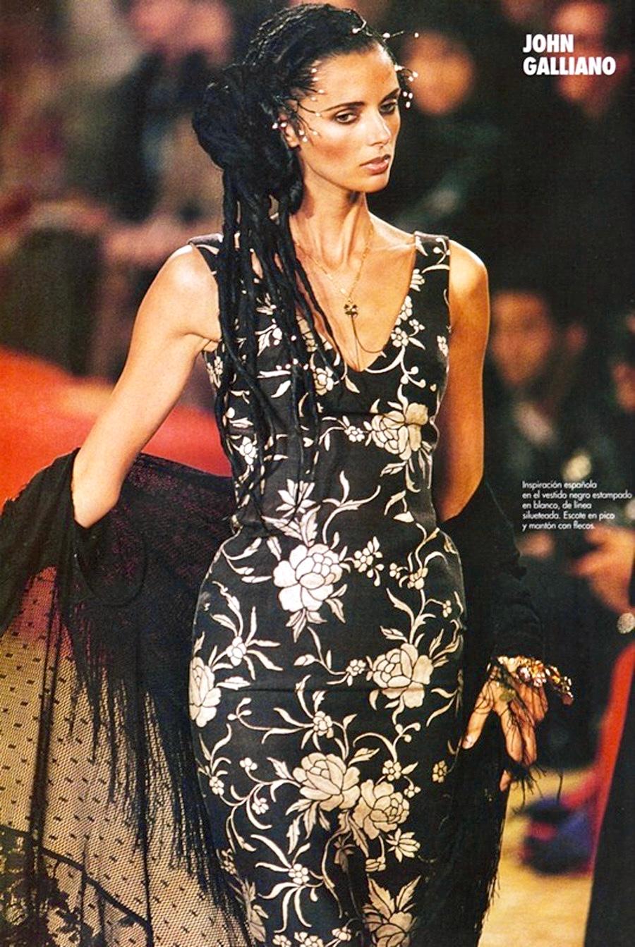 Presenting a stunning black lace John Galliano flamenco style shawl. From the Spring/Summer 1997 collection, this incredible shawl jacket debuted on the season's runway. Constructed entirely of intricate lace, this shawl features long sleeves, a