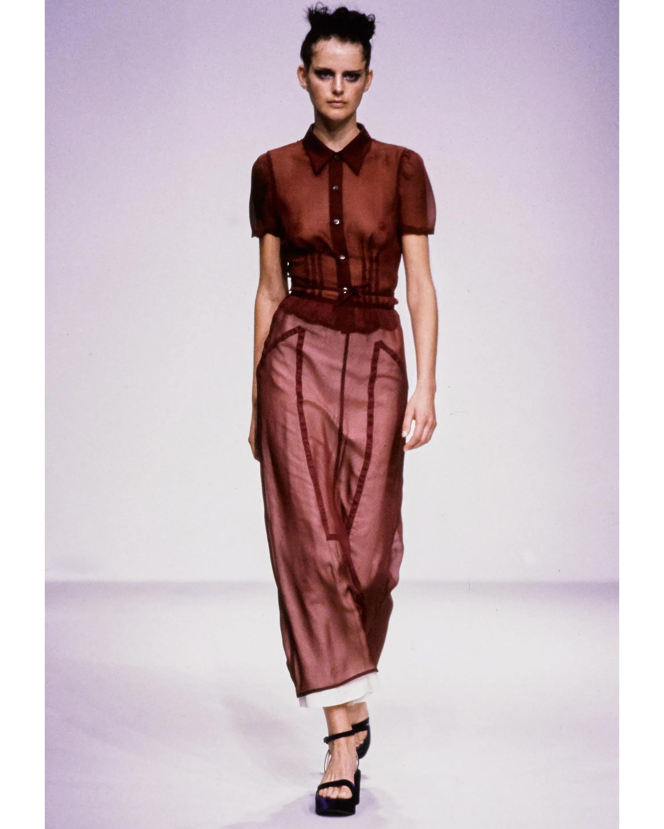 S/S 1997 Prada by Miuccia Prada merlot silk chiffon skirt set. Deep red collared semi-sheer shirt with front button closures and tie-waist design (can be styled tied in front or back). Features three line contrast detailing under breast and slightly
