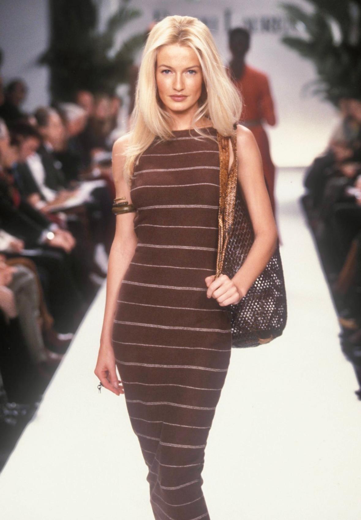 This stunning brown knit Ralph Lauren dress is from the Spring/Summer 1997 collection. This dress made its runway debut, worn by Karen Mulder during the season's presentation. The dress is entirely knit and has thin white stripes throughout. The