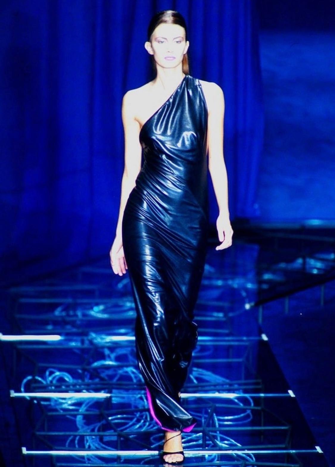 Presenting an incredible black and electric blue Gianni Versace Couture stretch gown, designed by Donatella Versace. From the Spring/Summer 1998 collection, this liquid-looking gown debuted with a pink/red lining on the season's runway and was also