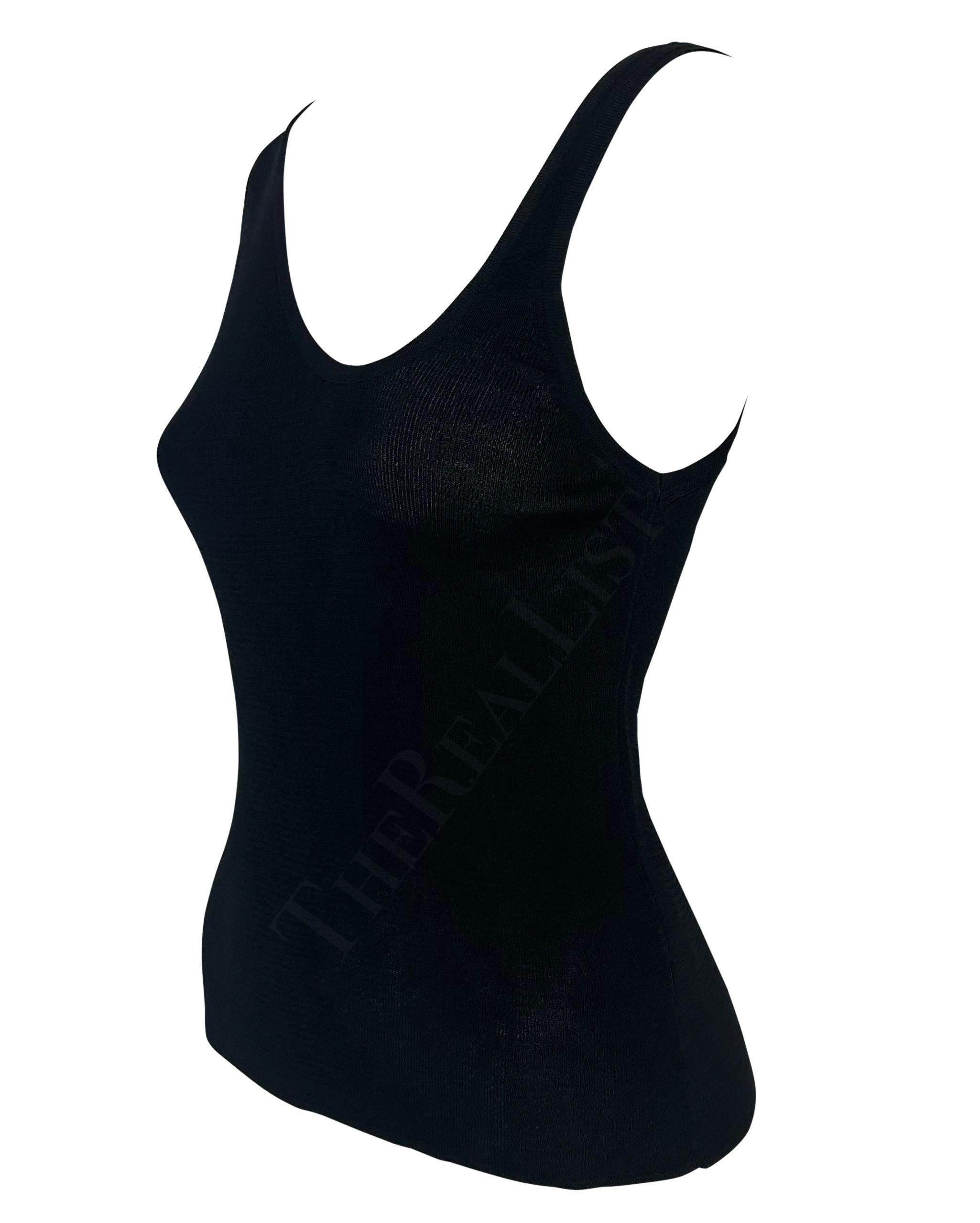 Presenting a fabulous knit black asymmetric Gucci tank top, designed by Tom Ford. Embrace the essence of refined allure with this elevated tank top from the Spring/Summer 1998 collection. Crafted with meticulous attention to detail, it showcases a