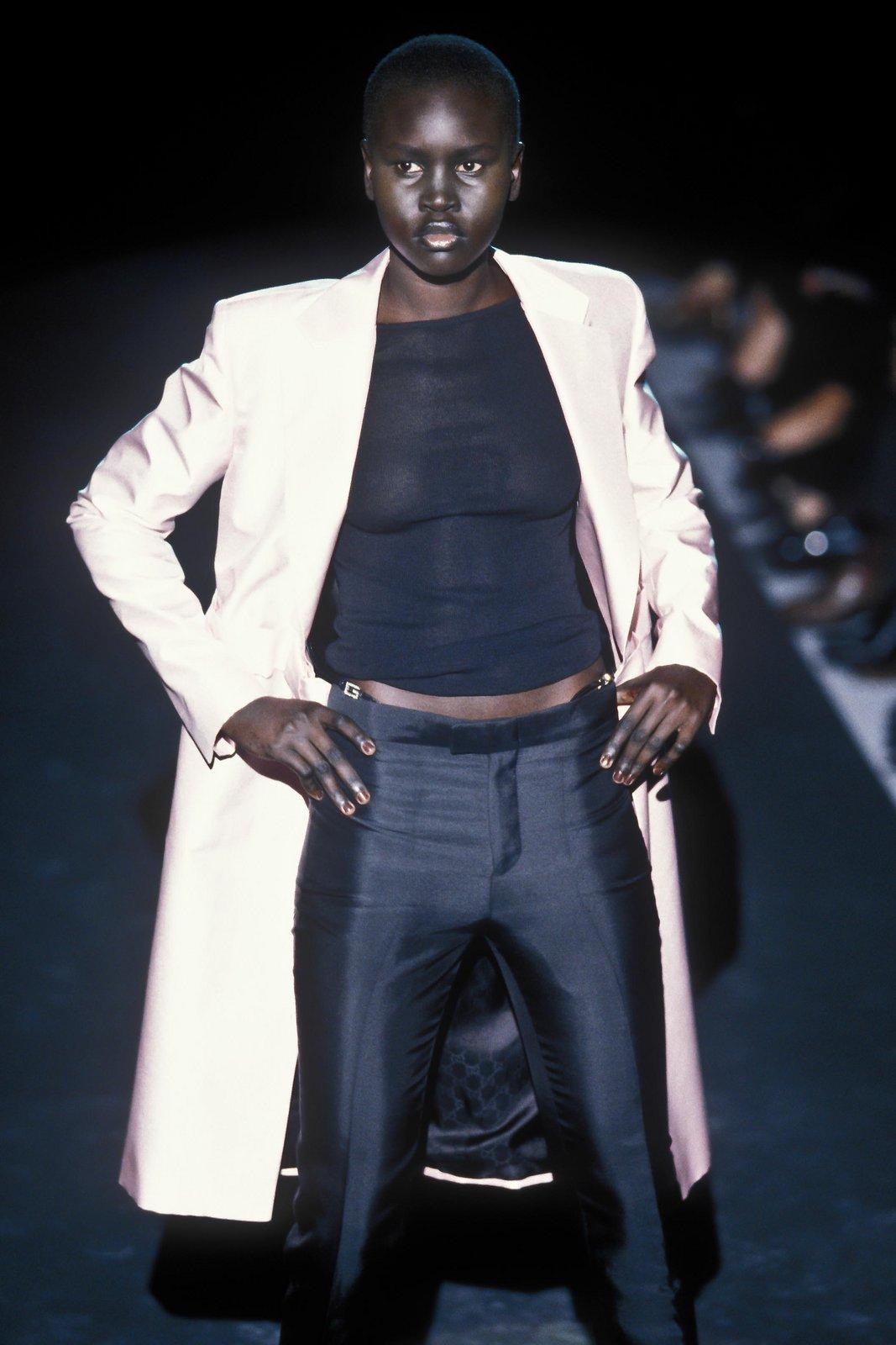 From Gucci’s Spring/Summer 1998 collection by Tom Ford, these black tailored pants feature faux exposed thong straps finished with square rhinestone “G” buckles. The slim-leg silhouette and daring waistband detail made them an iconic statement.