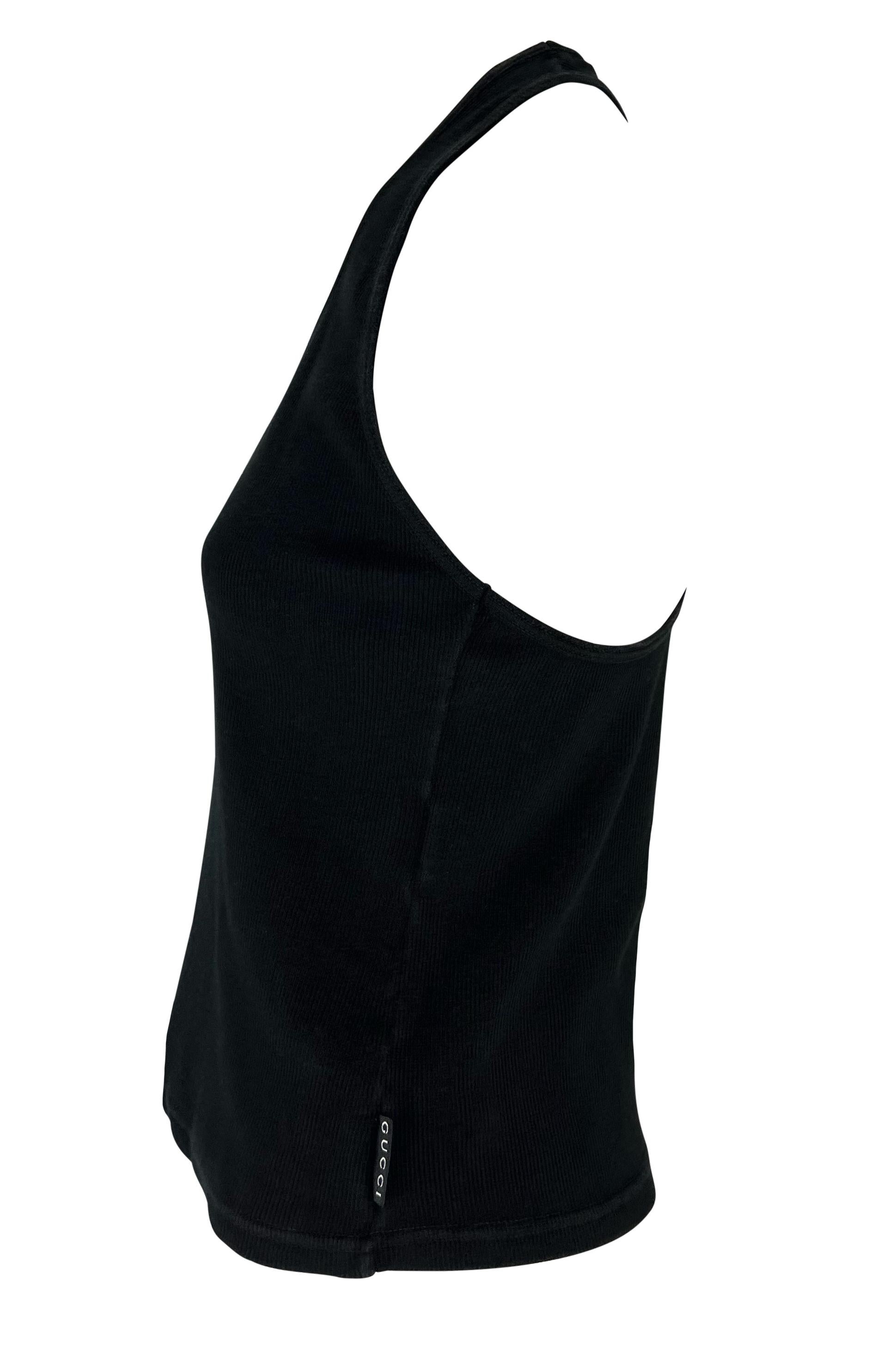 This black ribbed Gucci tank top, designed by Tom Ford for the Spring/Summer 1998 collection, features a scoop neckline and racerback. A 'Gucci' branded tag on the side adds a subtle touch. The perfect elevated closet staple, this Gucci by Tom Ford