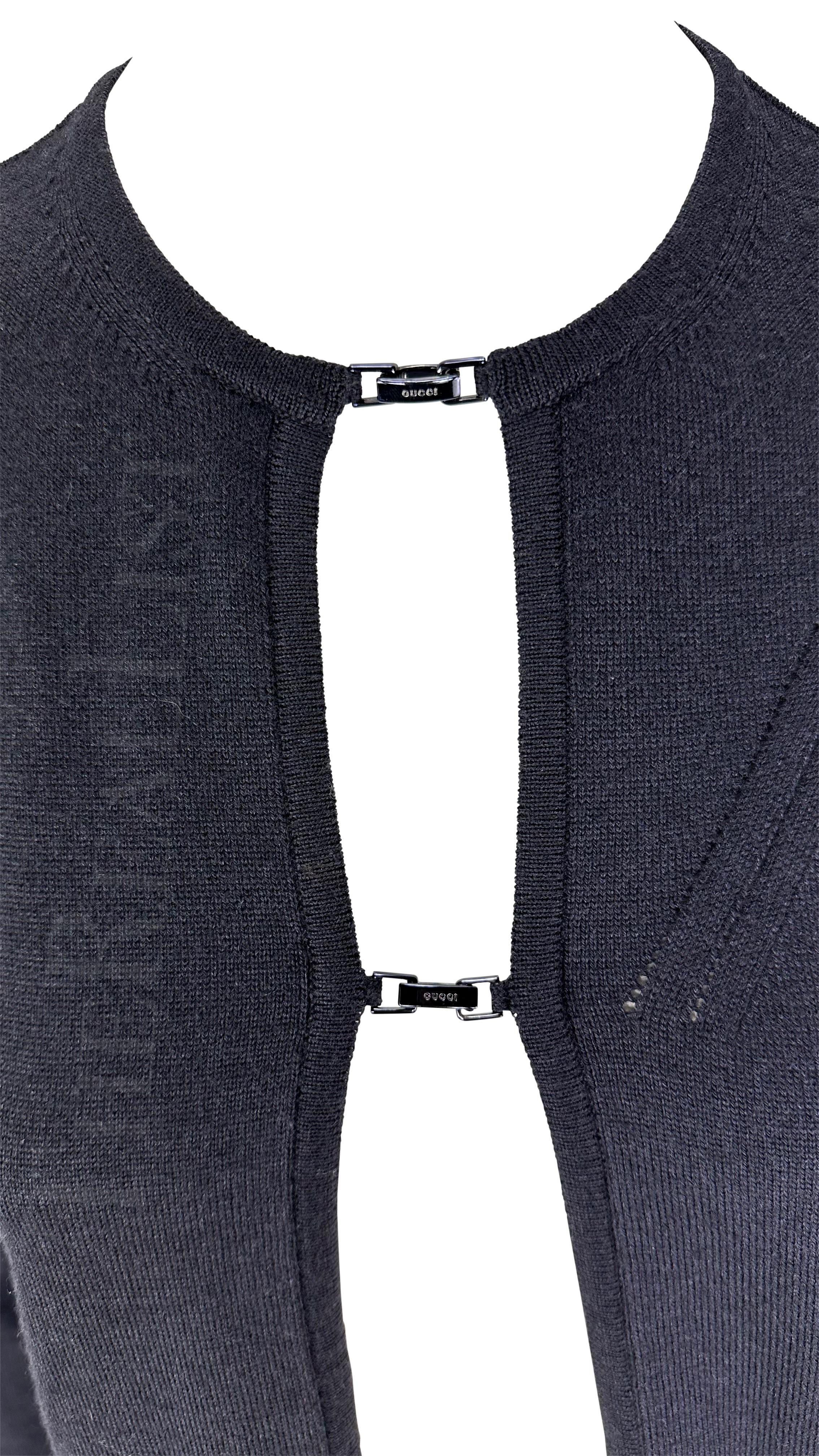 Présentation d'un cardigan Gucci en maille noire ouverte, dessiné par Tom Ford. Issu de la Collectional Automne/Hiver 1998, cet incroyable cardigan est doté de deux fermetures sur le devant, chacune marquée 'Gucci', qui laissent avec tact le pull