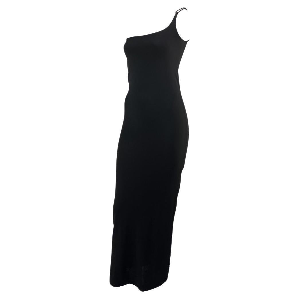 Presenting an iconic single shoulder black Gucci gown with a gunmetal 'G' strap, designed by Tom Ford for the Spring/Summer 1998 collection. This stunning gown drapes the body in a double layer of viscose fabric, enhancing the wearer's curves. This