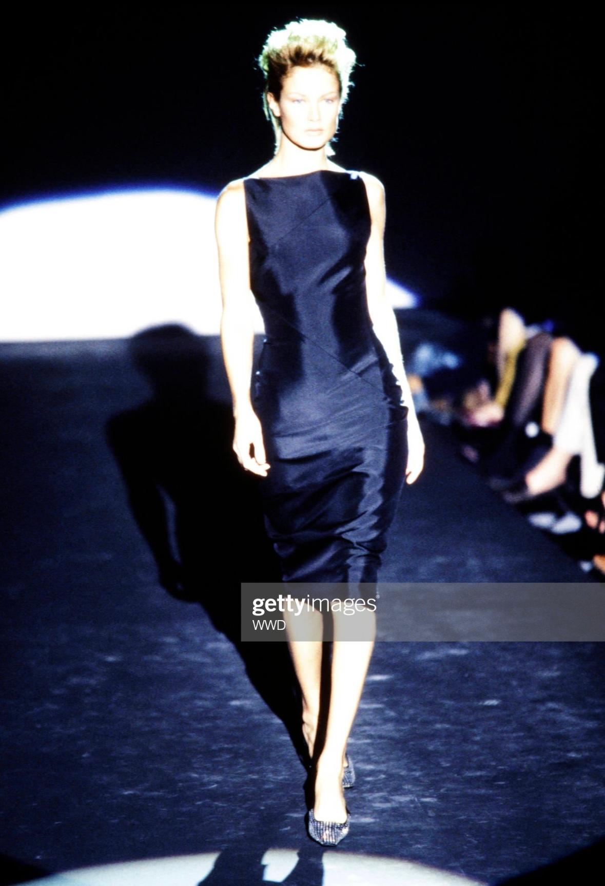 Presenting a black silk satin Gucci dress, designed by Tom Ford. From the Spring/Summer 1998 collection, this dress debuted on the season's runway and was also highlighted in the season's ad campaign, captured by Luis Sanchis. The dress features a