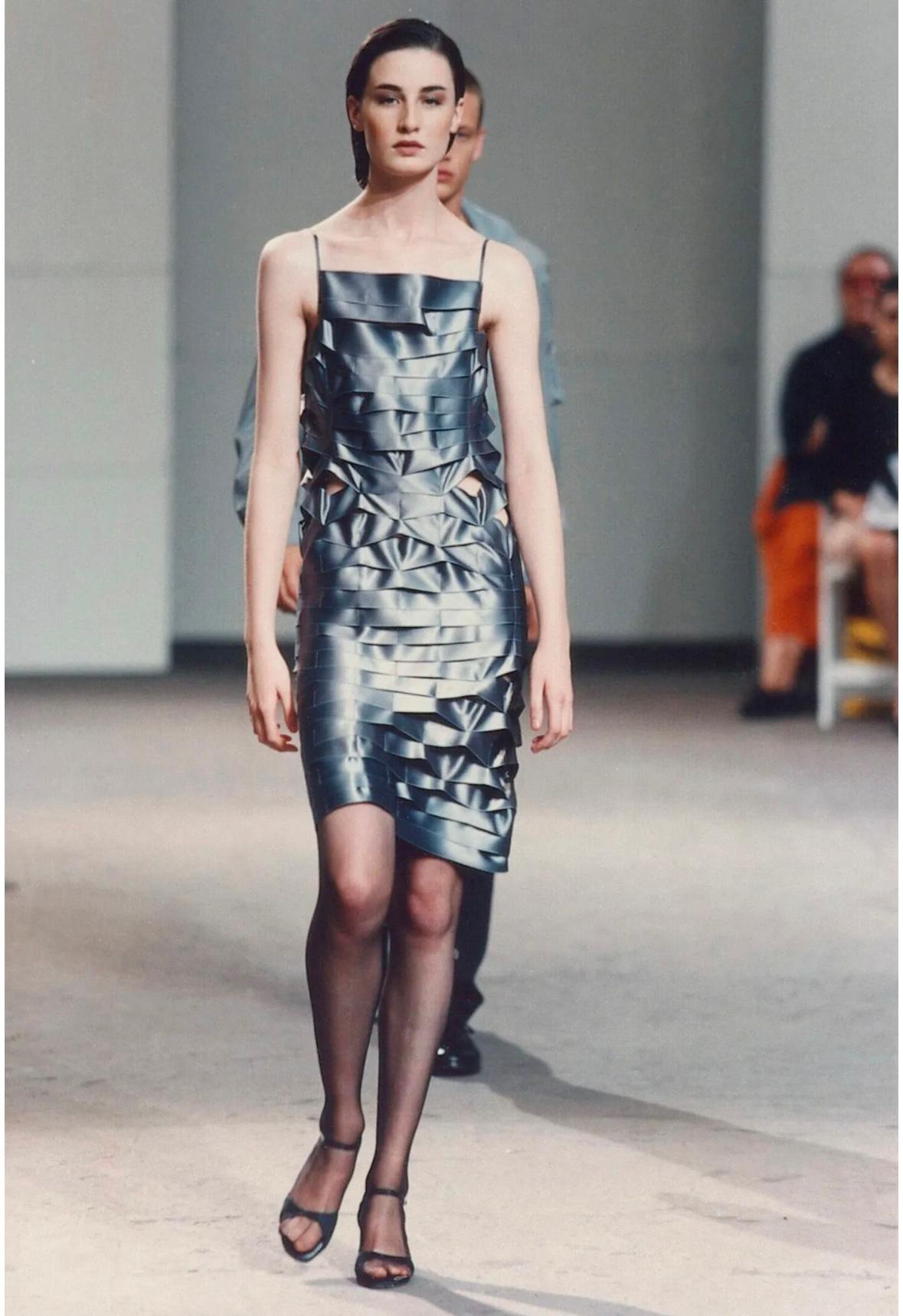 From the Spring/Summer 1998 collection, several versions of this Helmut Lang silk satin dress debuted on the season's menswear runway. This unique slip-style dress features two thin shoulder straps and a square neckline. It is completely crafted of