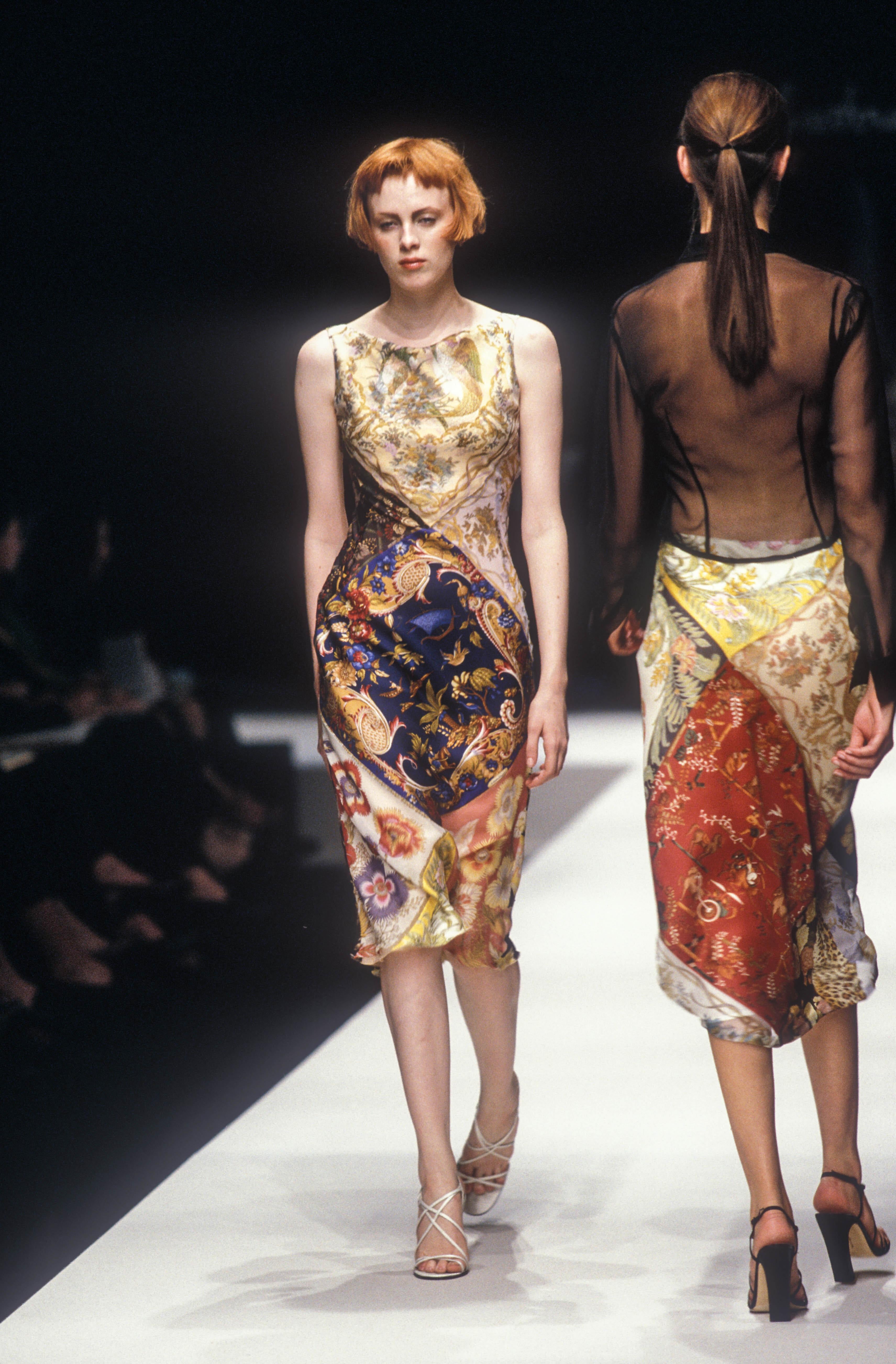 From Salvatore Ferragamo’s Spring/Summer 1998 collection, this sleeveless dress is constructed from a patchwork of printed silk scarves featuring florals, felines, and mythological motifs. With an asymmetric silhouette and cutouts at the back