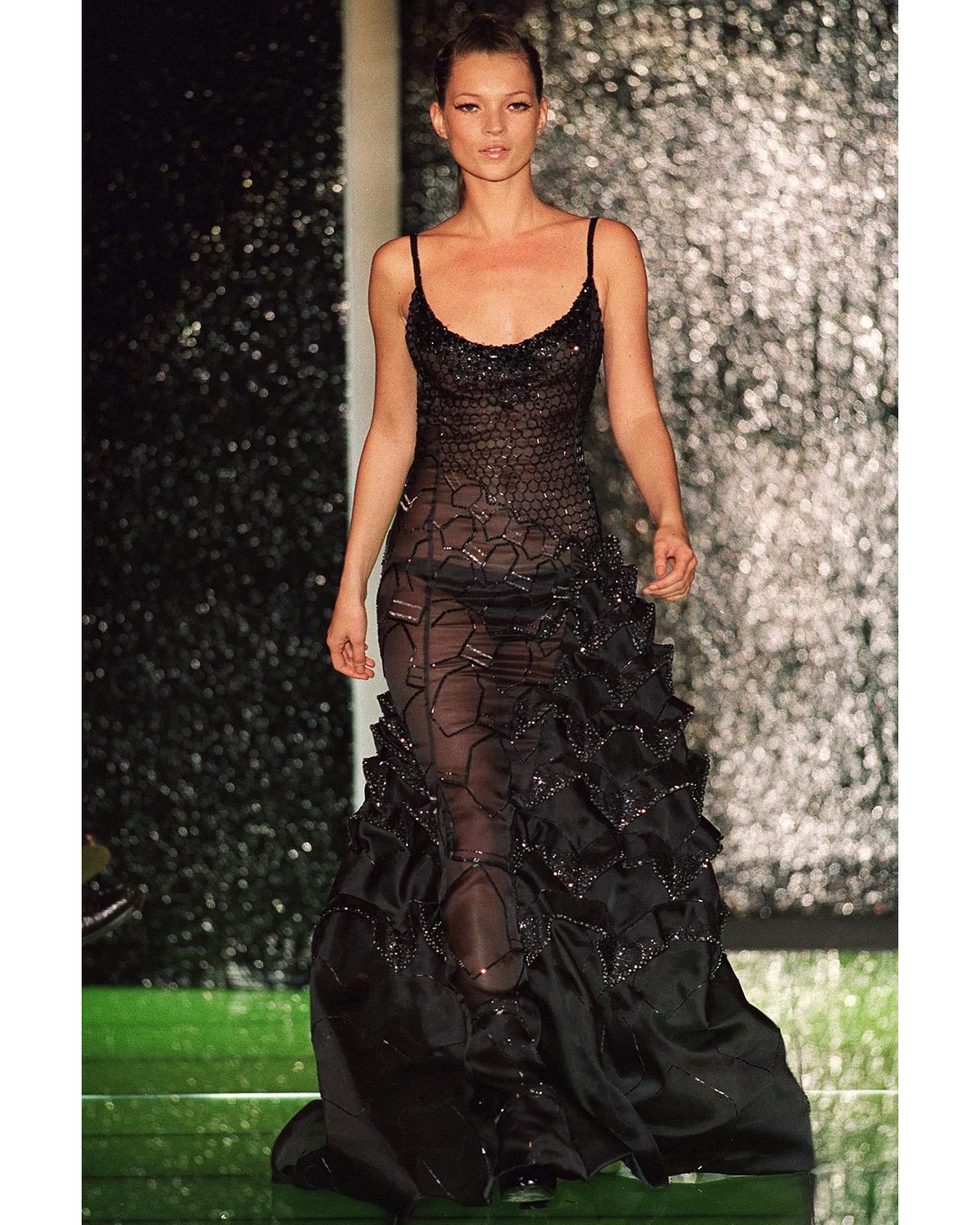 S/S 1999 Atelier Versace (Haute Couture) black embellished sculptural gown. Embellished sleeveless silk gown with honeycomb shaped embellishments at bust and 3D scalloped architecture threaded with clear and black hand-beaded embellishments