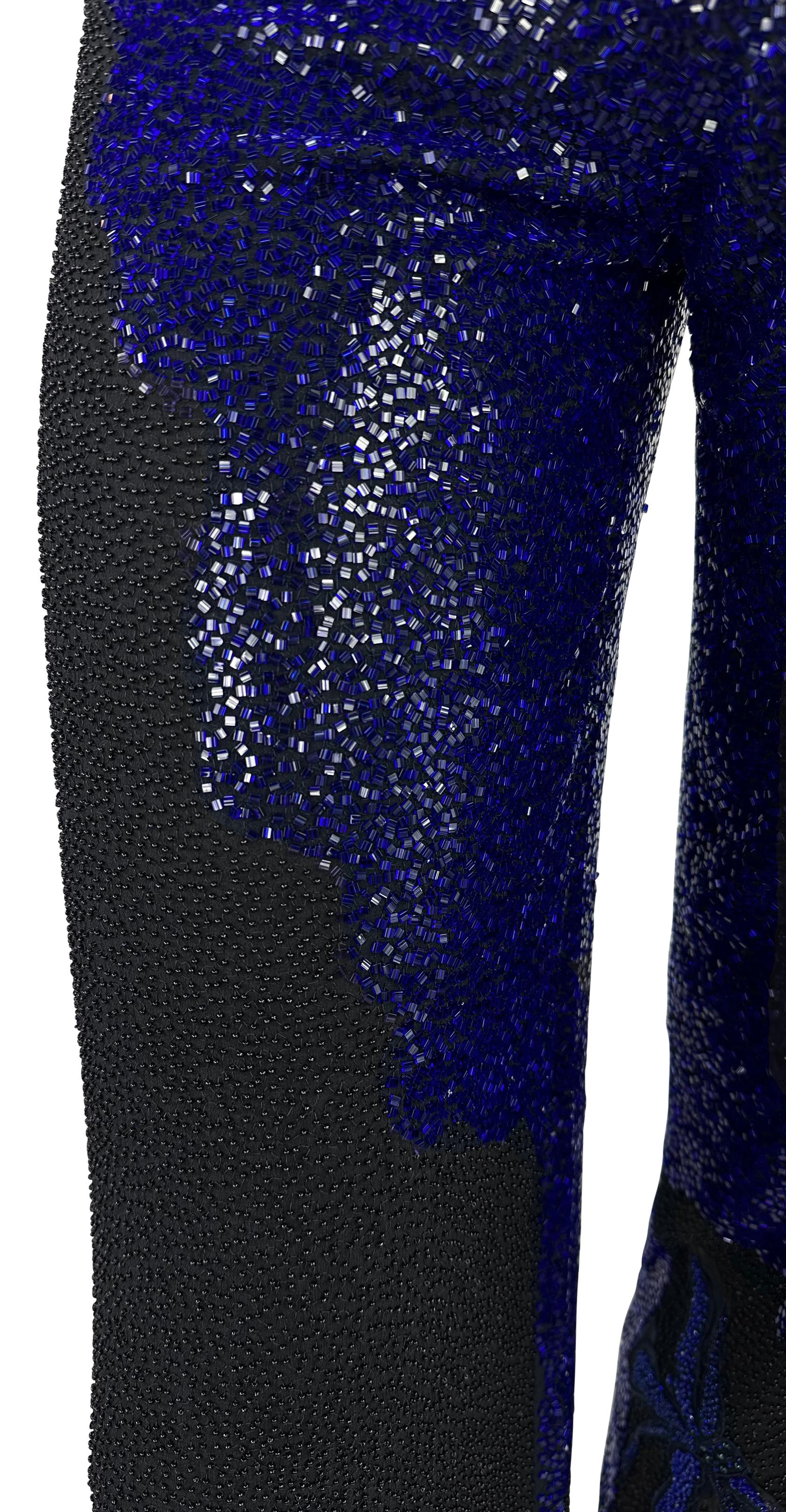 Donatella Versace designed these stunning handmade black and deep blue beaded pants for her Spring/Summer 1999 Atelier Versace Haute Couture collection. These wide-leg, flare-cut pants are intricately adorned with black and blue beads from waist to