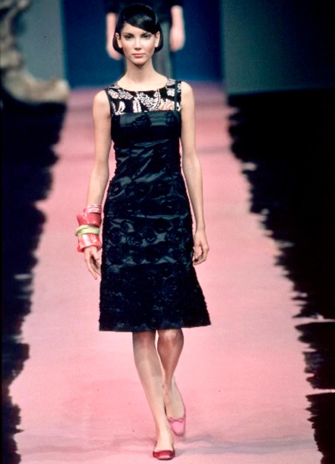This beautiful black strapless gown was created for the Christian Lacroix Spring/Summer 1999 collection, with similar pieces being highlighted on the season's runway. Classically chic, this floor-length gown features floral appliqués at the skirt, a
