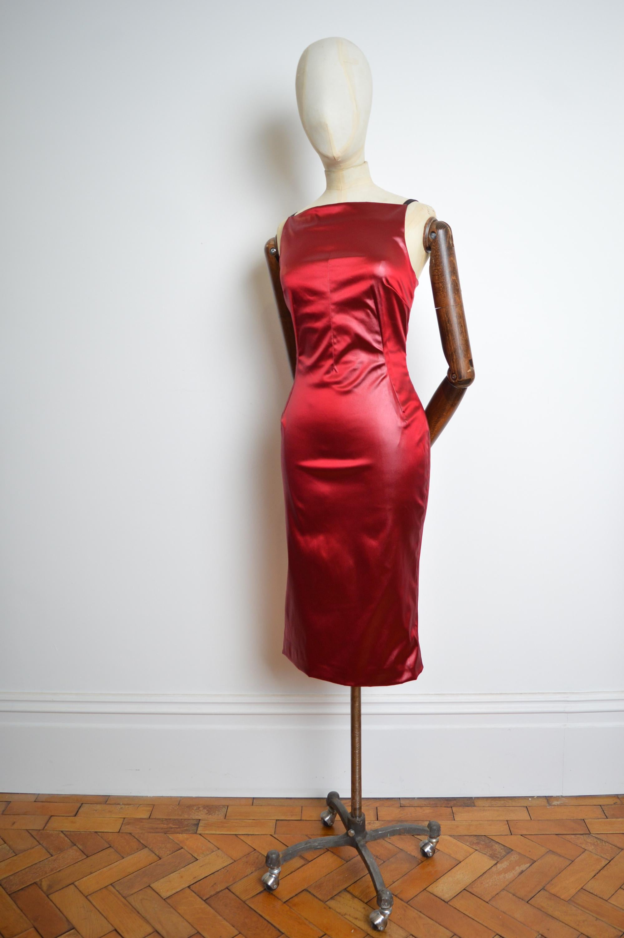 A Divine wet-look effect dress, crafted from a shiny, red satin material from Dolce & Gabbana’s Spring/ Summer 1999 Collection. Featuring square neck-line, fully adjustable shoulder straps, stretchy, figure-hugging silhouette with a boned interior