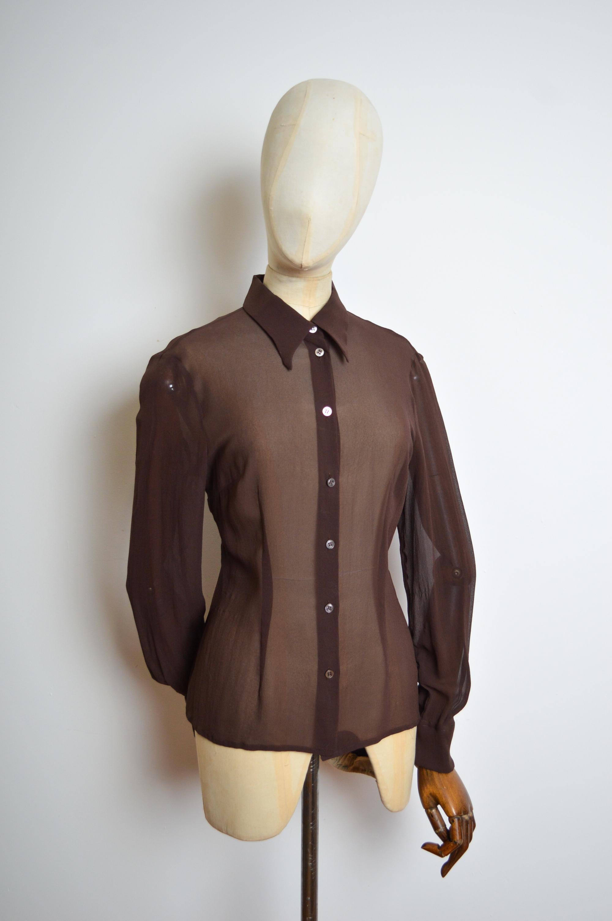Spring / Summer 1999 Chocolate Brown Pure Silk Sheer Runway Shirt.
Features ; long sleeves, mother of pearl Buttons down the front, sheer texture, fitted shape. Timeless piece. 
MADE IN ITALY!
Pit to Pit; 19’’
Pit to Cuff; 19.5’’
Nape to Hem;