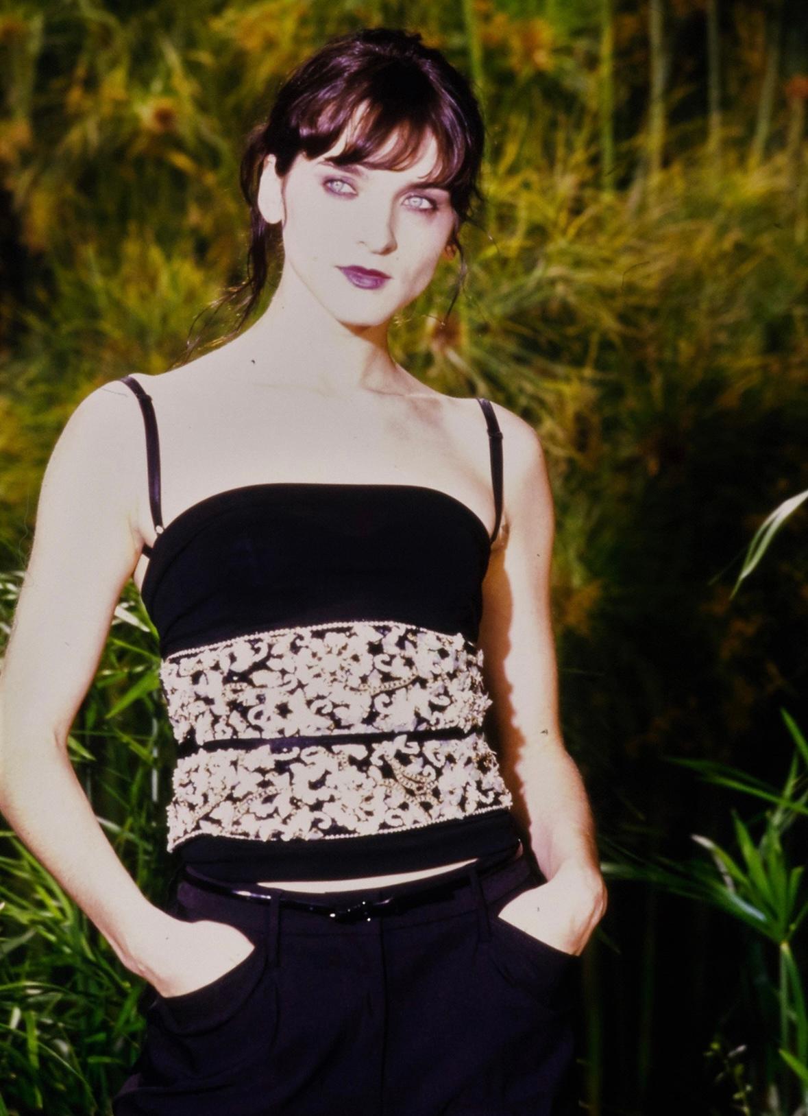 Presenting a fabulous black floral Dolce & Gabbana waist belt. From the Spring/Summer 1999 collection, this intricate waist belt debuted on the season's runway as part of look 45, modeled by Michele Hicks. This wide belt/corset features a black wrap