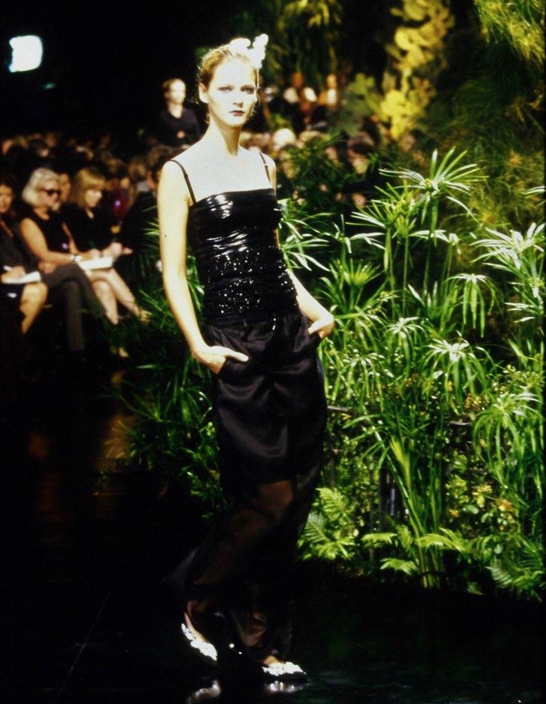 Presenting a fabulous black metallic Dolce and Gabbana bustier crop top. From the Spring/Summer 1999 'Silicy Through the Internet' collection, this top debuted on the season's runway modeled by Carmen Kass. This incredible top is constructed of a