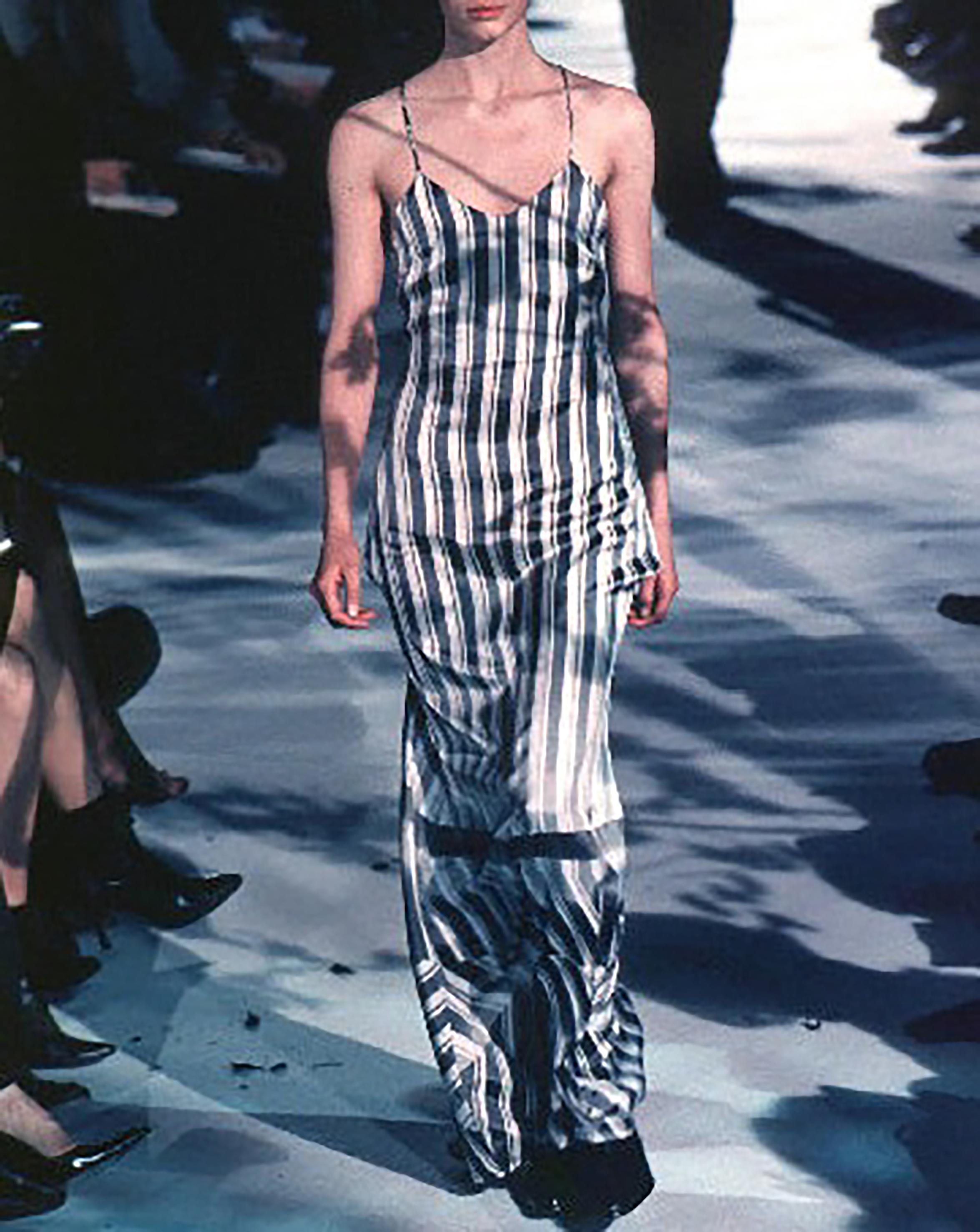 S/S 1999 Dries van Noten white and gray gradient stripe bustle gown. Spaghetti strap gown with long hem that can be buttoned into bustle. Cross-back straps and back zip closure. Bustle connects easily with built-in white button closures. As seen on