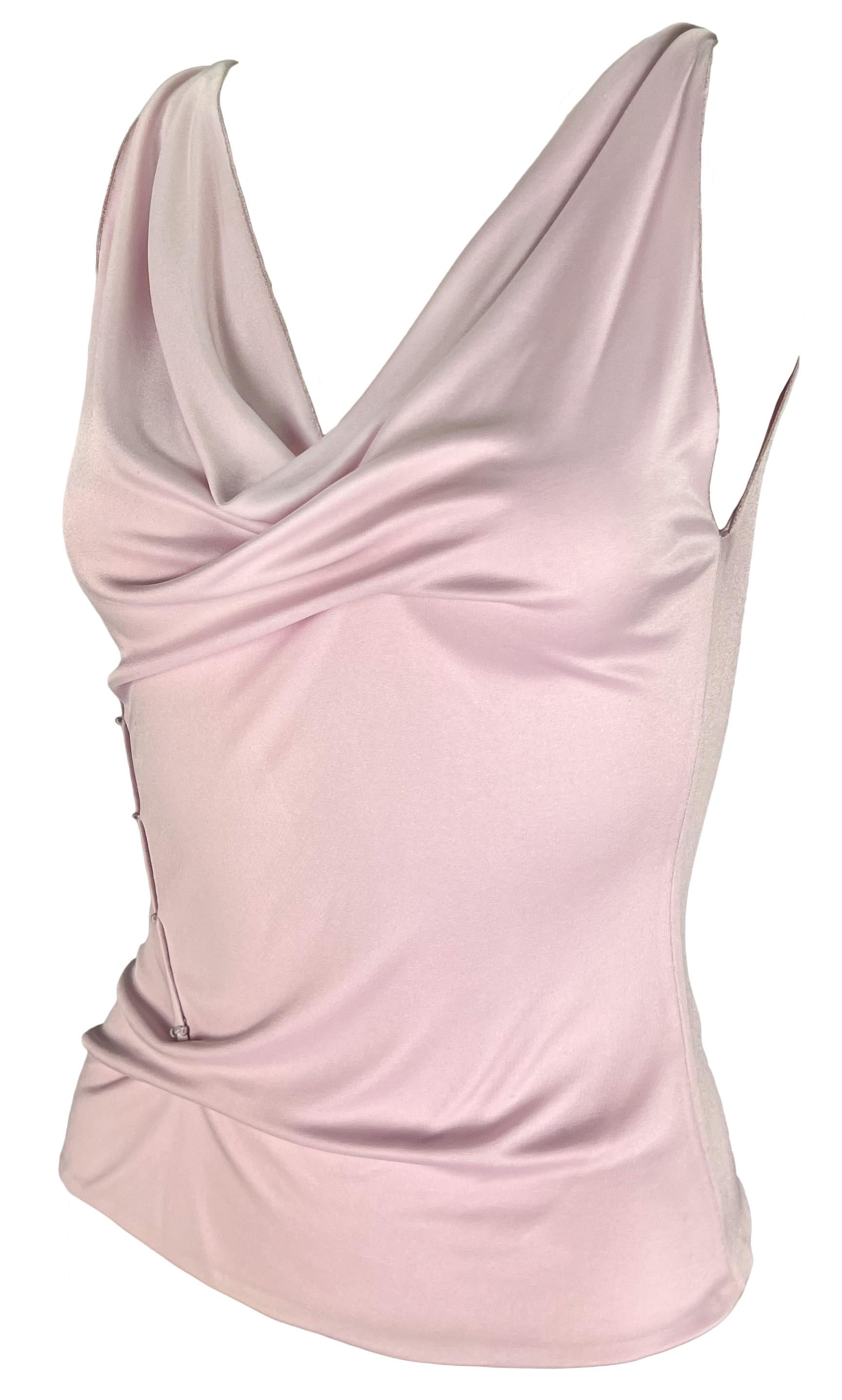 This pastel pink Gianni Versace tank top from the Spring/Summer 1999 collection features a cowl neck and pinched shoulders. Designed by Donatella Versace, this taut top is elevated with a pinched detail at the front and is made complete with a piece