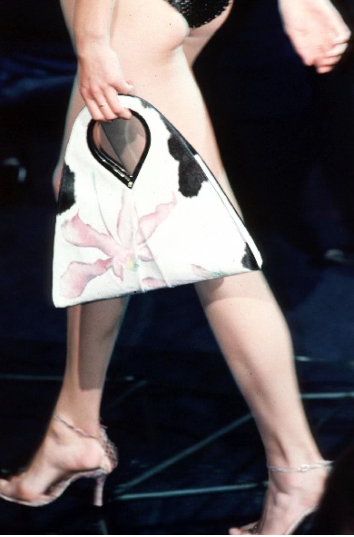 Debuting on the season's runway, this Donatella-designed Gianni Versace bag was created for the Spring/Summer 1999 collection. Constructed entirely of spotted pony hair and complete with large hand-painted purple flowers, similarly painted bags were