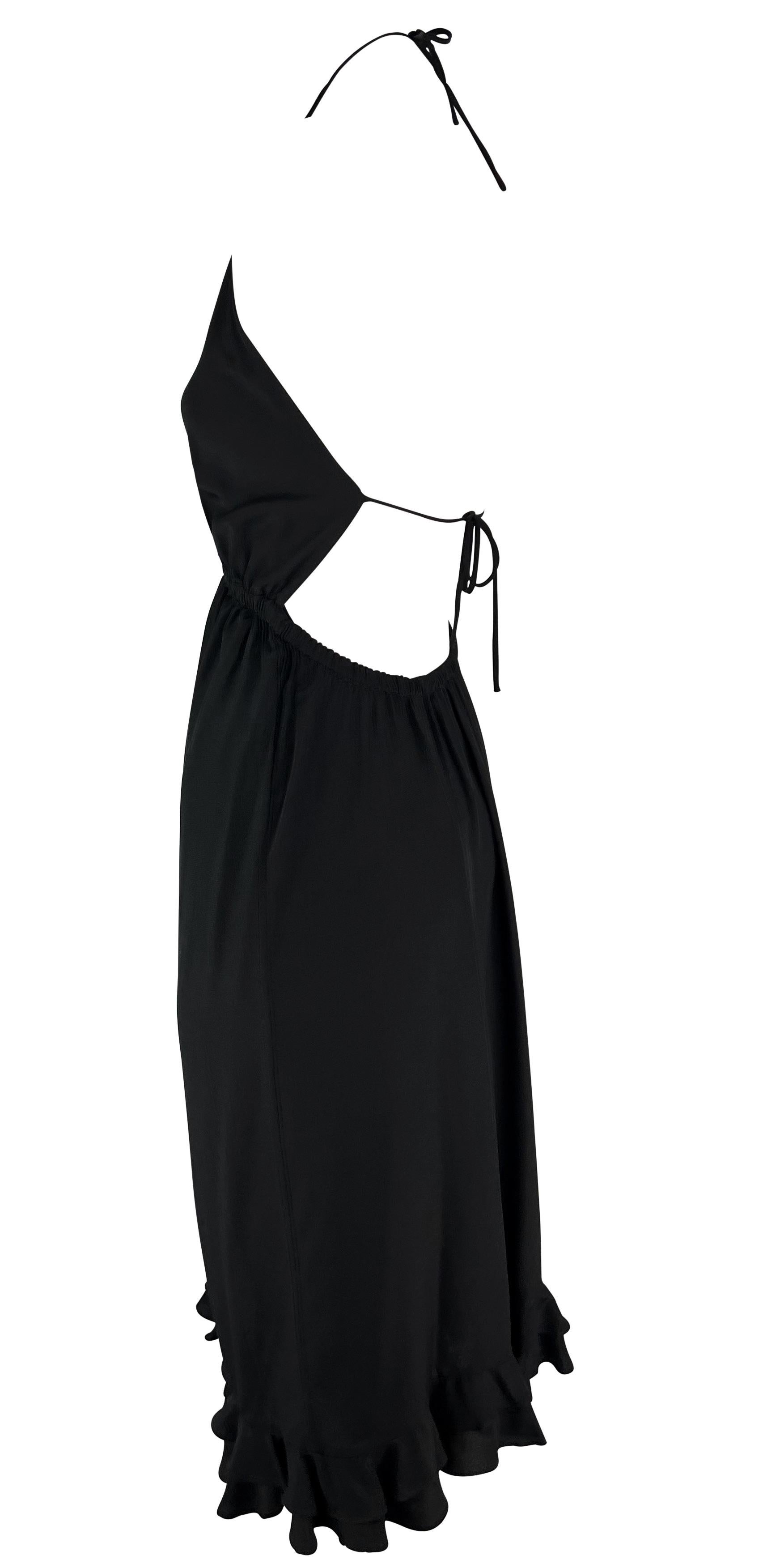 From the Gucci Spring/Summer 1999 collection, this chic Tom Ford-designed black cocktail dress is a warm-weather must-have. This backless halterneck dress features a thin spaghetti strap tie at the nape and behind the bust. The dress is complete