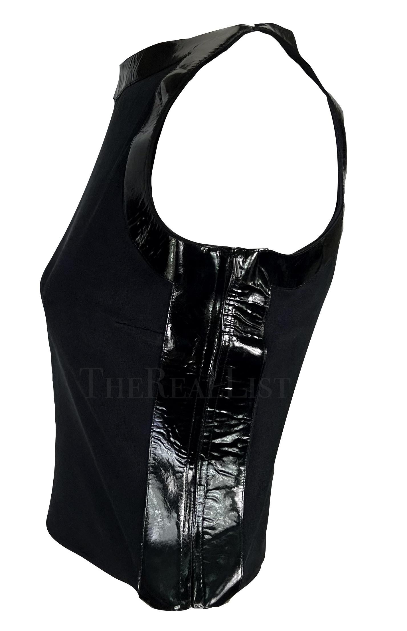 Presenting a black Gucci crop top, designed by Tom Ford. From the Spring/Summer 1999 collection, this semi-sheer top features a high boat-style neckline and is amped up with black patent leather accents on either side, around the arm holes, and