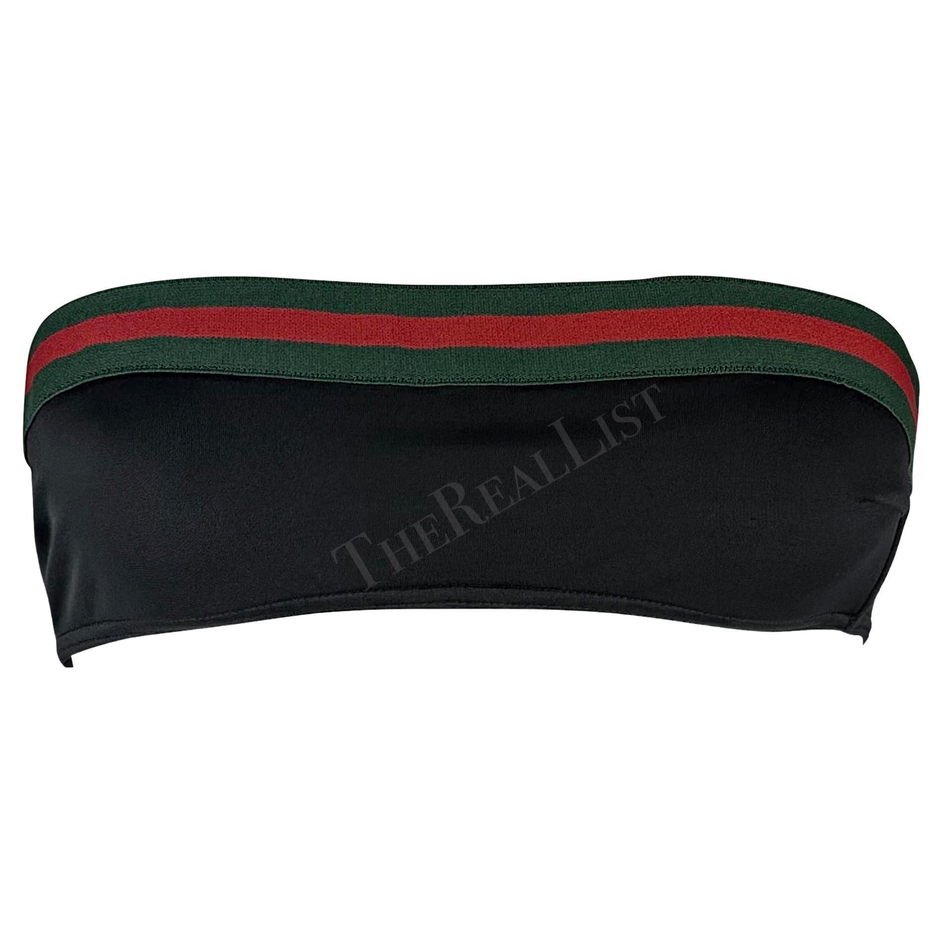 Presenting a black Gucci swim tube top, designed by Tom Ford. From the Spring/Summer 1999 collection, this chic strapless bikini top features the classic green and red Gucci striped webbing that wraps around the top and is made complete with a black