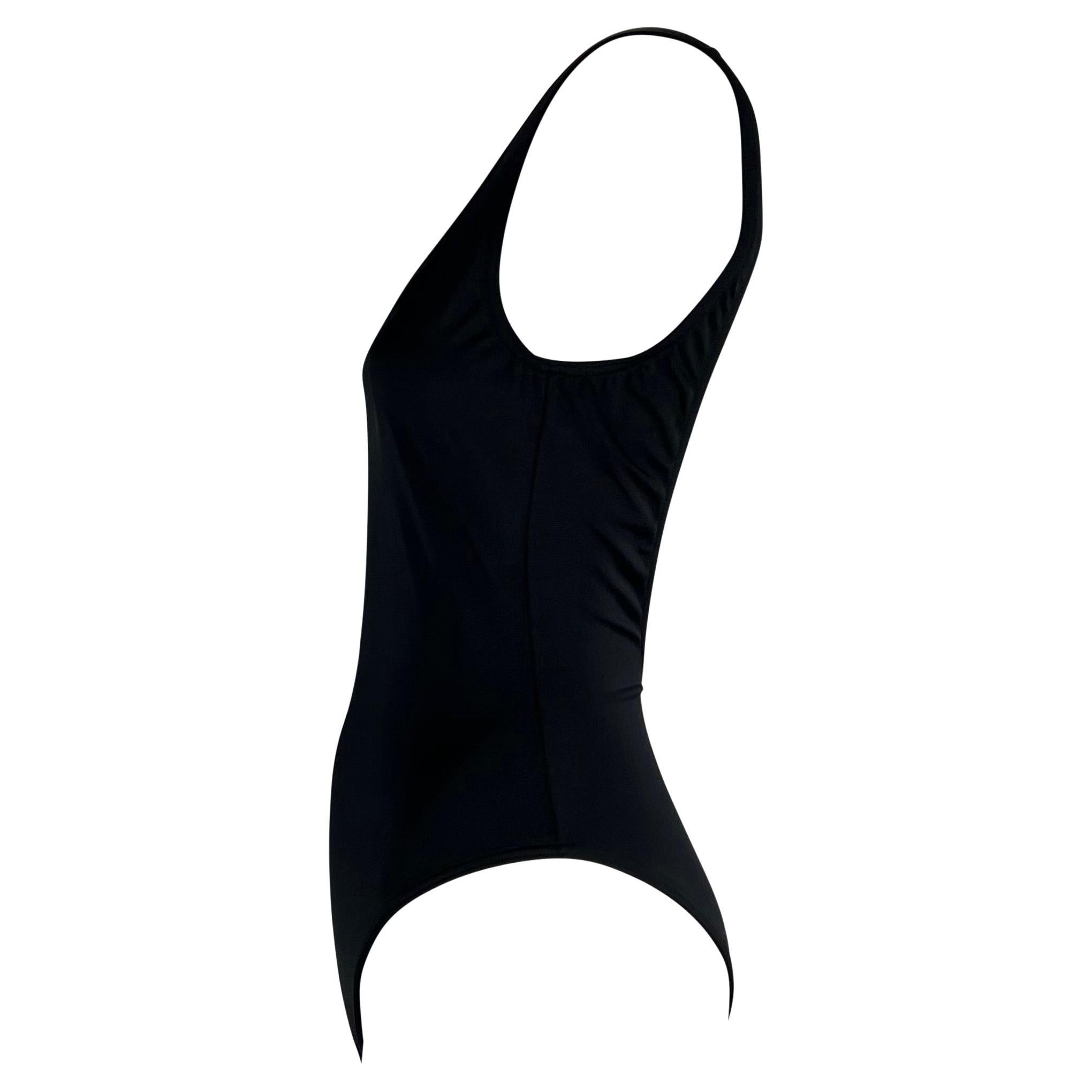 TheRealList presents: a gorgeous navy blue Gucci one piece swimsuit, designed by Tom Ford. From the Spring/Summer 1999 collection, this bathing suit features a scoop neckline and open back. This beautiful and hard to find piece is a must have for