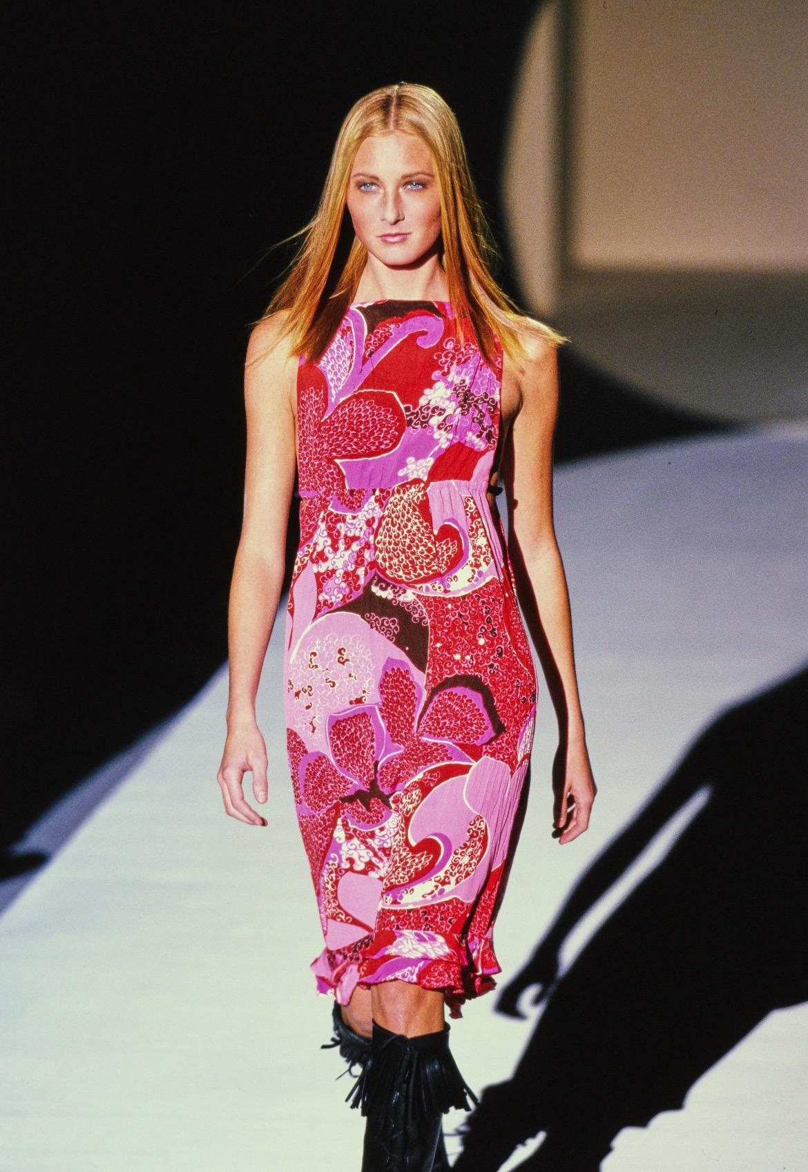 Presenting a bright floral Gucci dress, designed by Tom Ford. From the Spring/Summer 1999 collection, this dress debuted on the season's runway as look number 9, modeled by Maggie Rizer. This dress features Ford's bright red and pink 'acid flower'