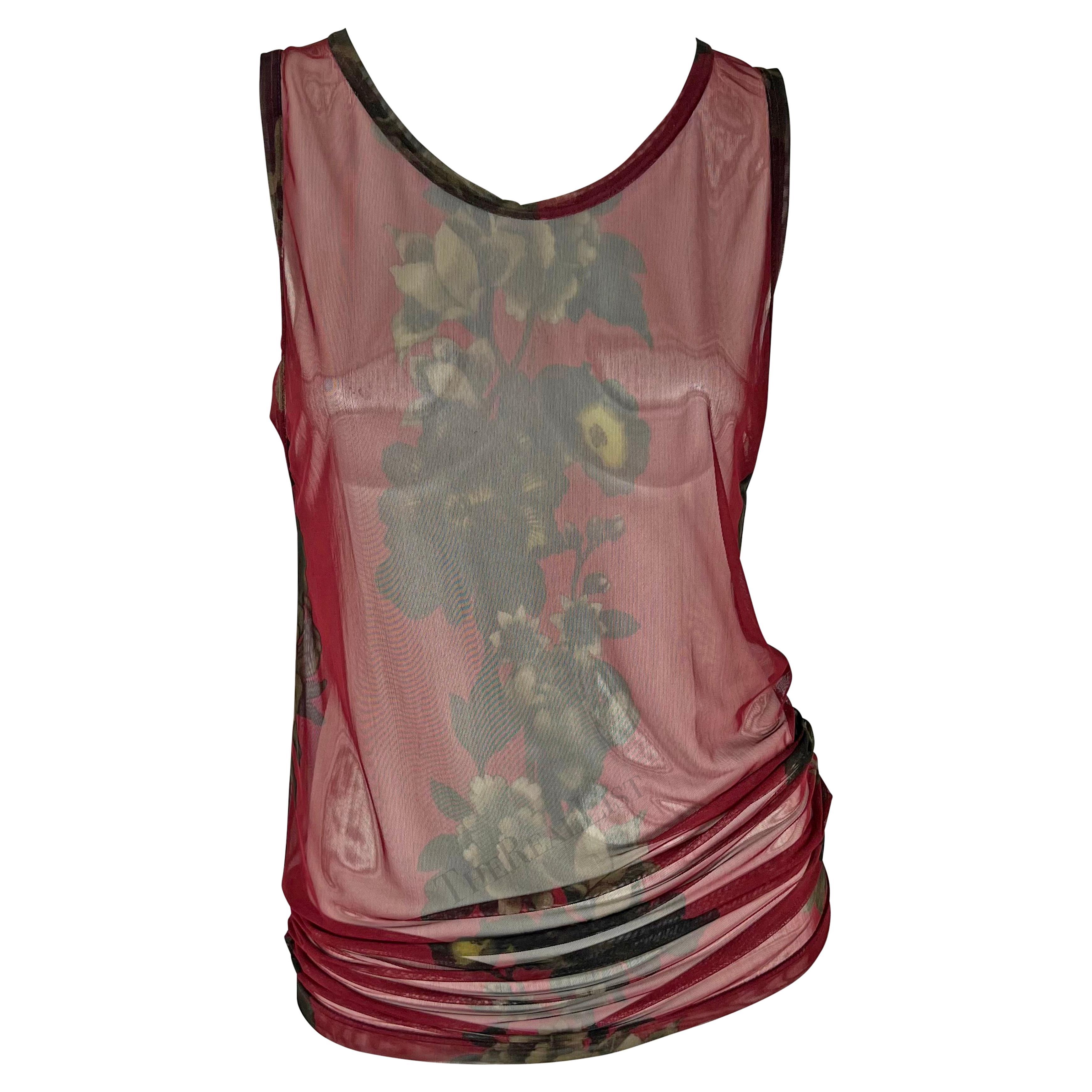 TheRealList presents: a chic red mesh men's Gucci tank top, designed by Tom Ford. From the Spring/Summer 1999 collection, this red shirt features a monotone floral print down the center of the top. Truly unisex, this piece can easily be worn as a