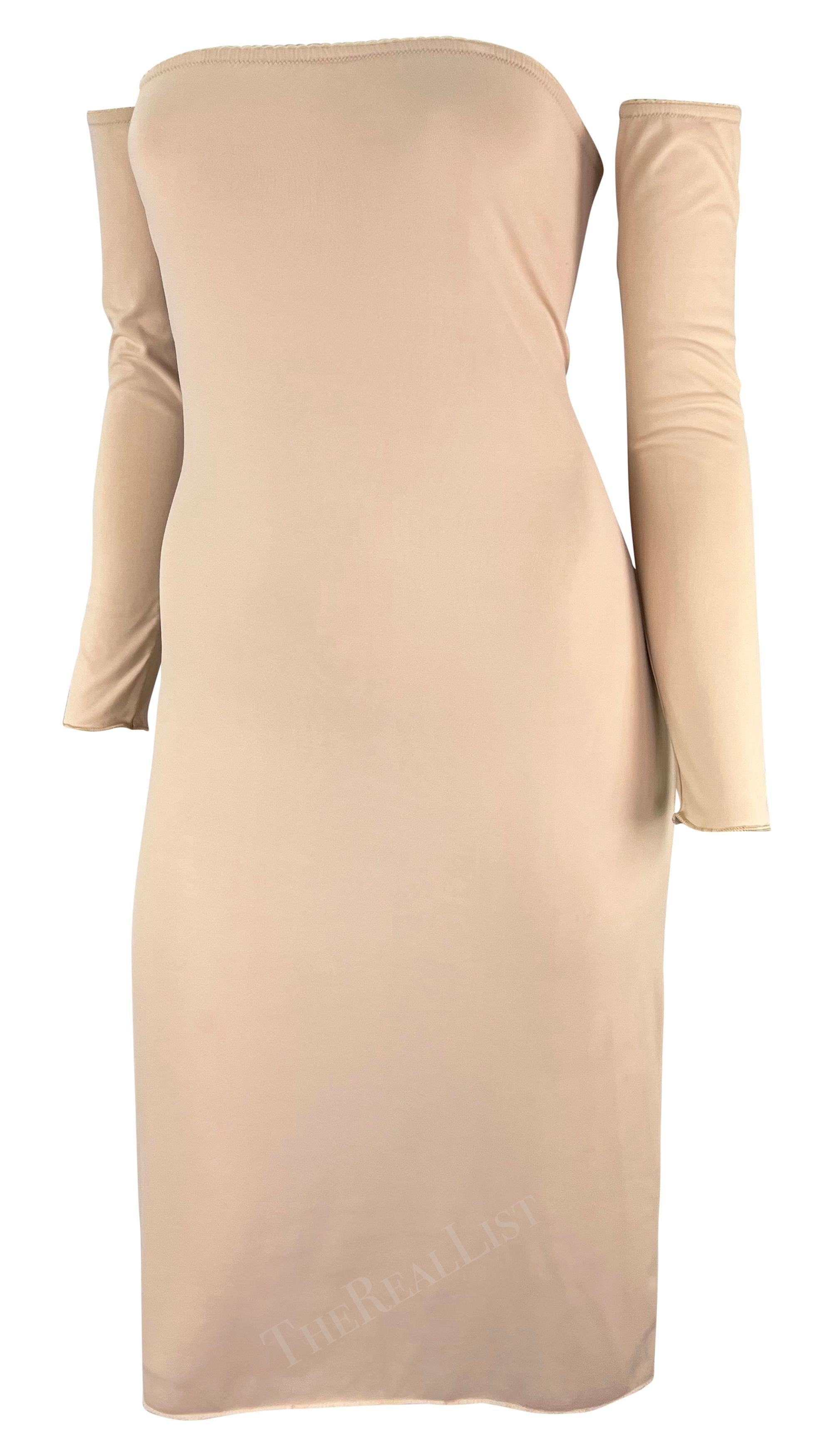This Spring/Summer 1999 Maison Martin Margiela beige stretch slip dress features a tube silhouette with detached arm sleeves. Crafted from lightweight stretch fabric in a versatile beige tone, it embodies Margiela’s iconic minimal deconstructionist