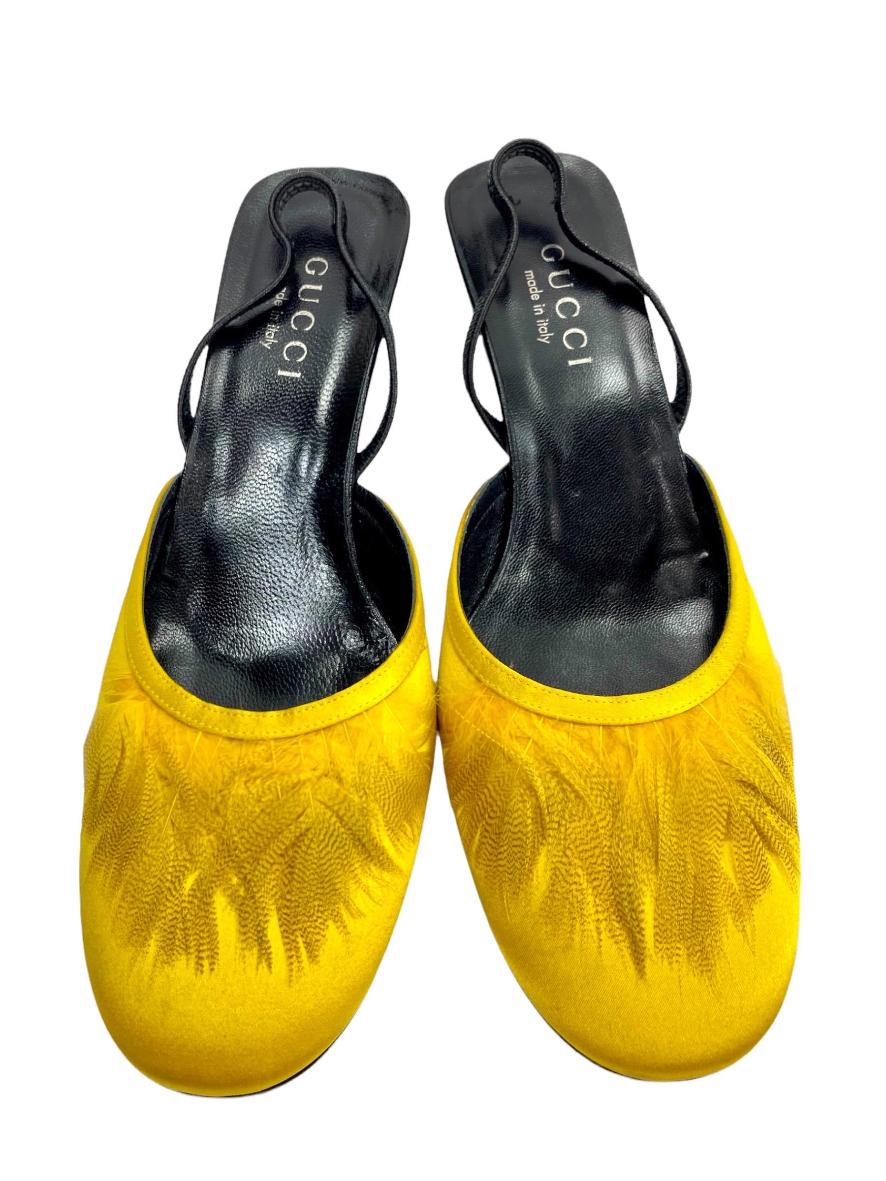 Highly Collectible Pair of shoes from Tom Ford's Era 
S/S 1999 Collection
Size: US - 8 B
Color: Yellow, Crepe Satin, Leather Lining and Sole, Finished with Feathers, Heel measures approx. - 2 inches.
Made in Italy.
Brand new, in excellent condition.