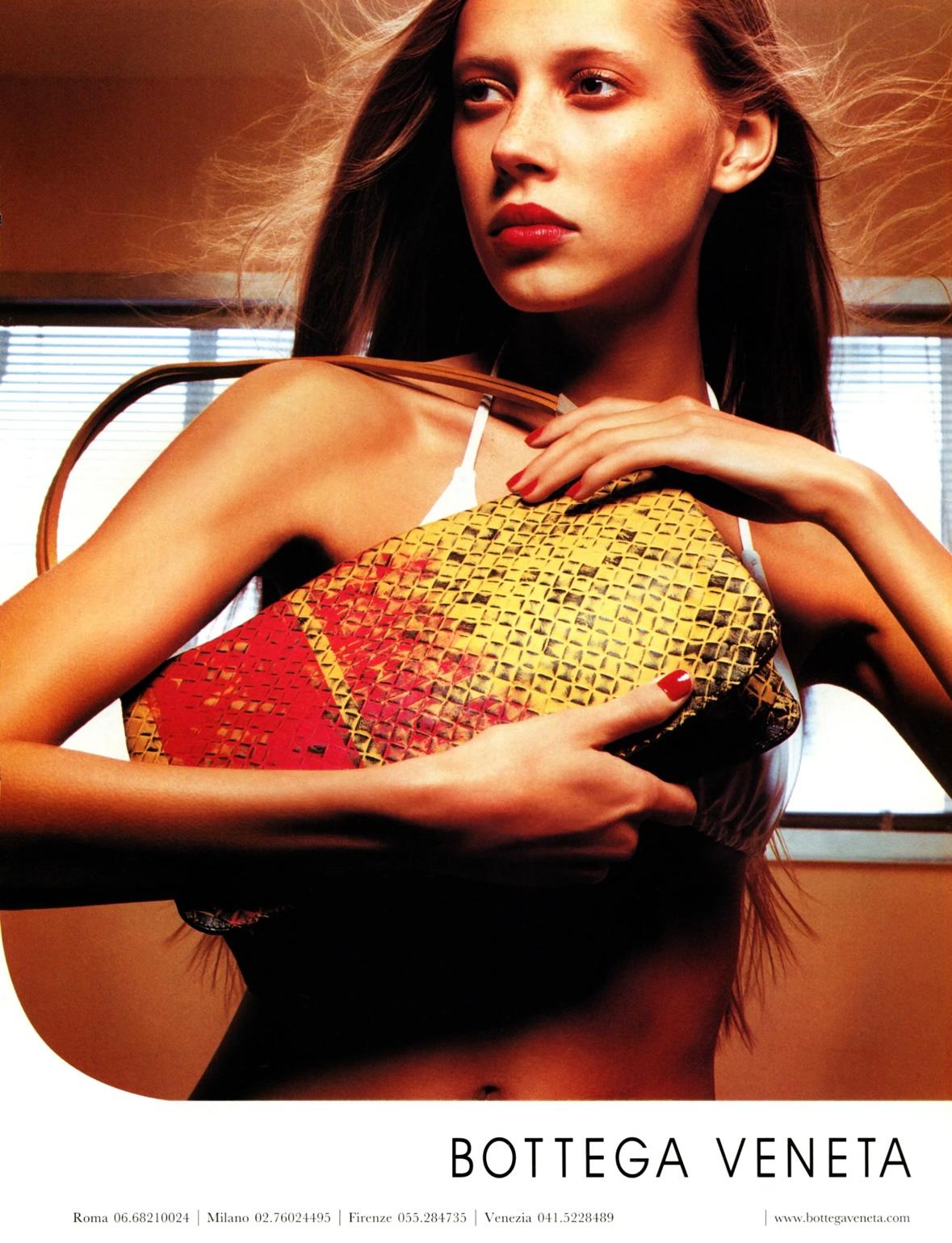 From the Bottega Veneta Spring/Summer 2000 collection, a variation of this vibrant orange lizard skin bag debuted on the season's runway, modeled by Alek Wek. Another variation appeared in the season's ad campaign on Collette Pechekhonova, captured