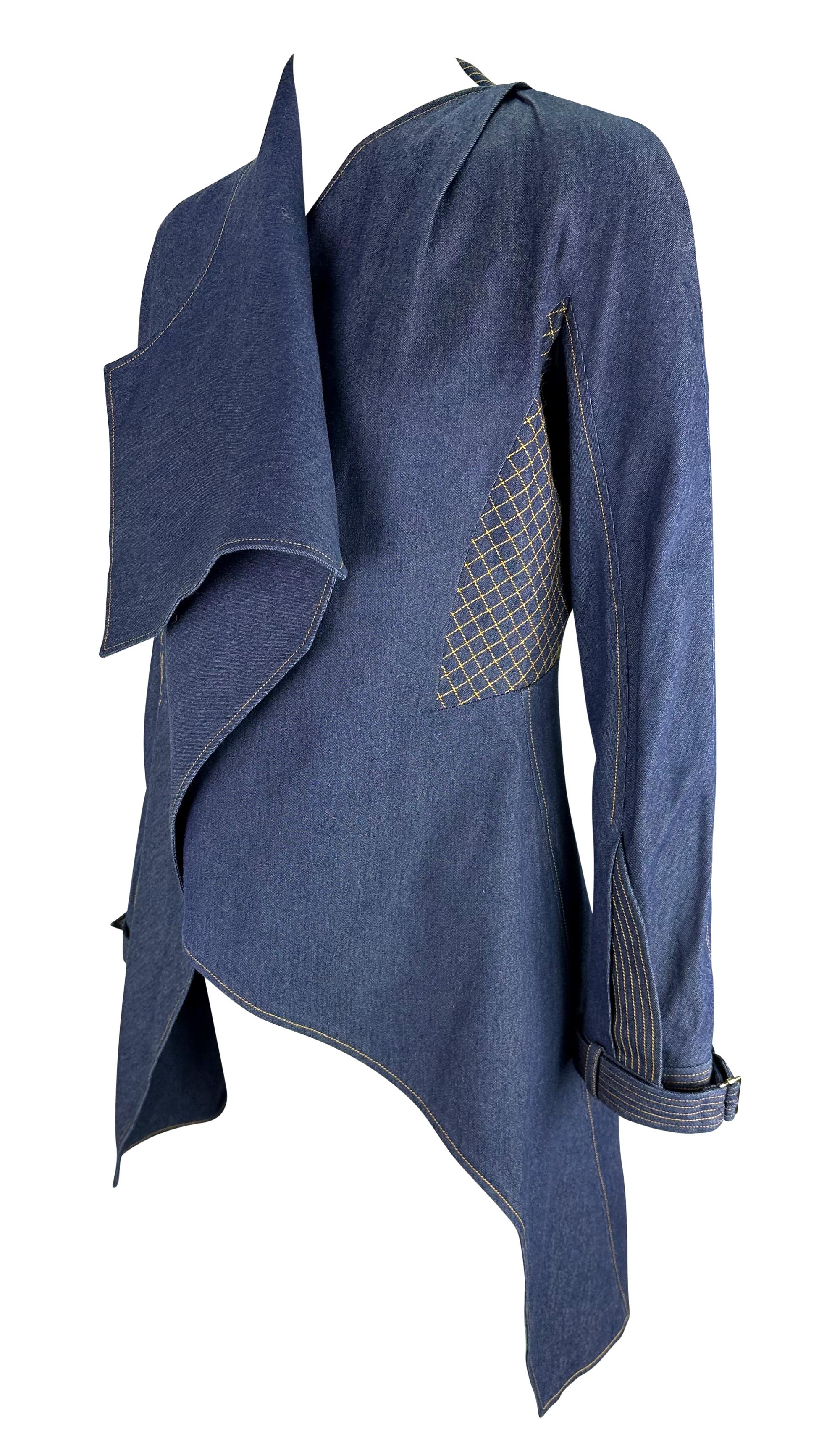 This oversized Christian Dior denim jacket, designed by John Galliano for the Spring/Summer 2000 collection, is made entirely of denim with yellow quilted stitching throughout. It features buckled cuffs, a wrap-style closure, and an asymmetric hem