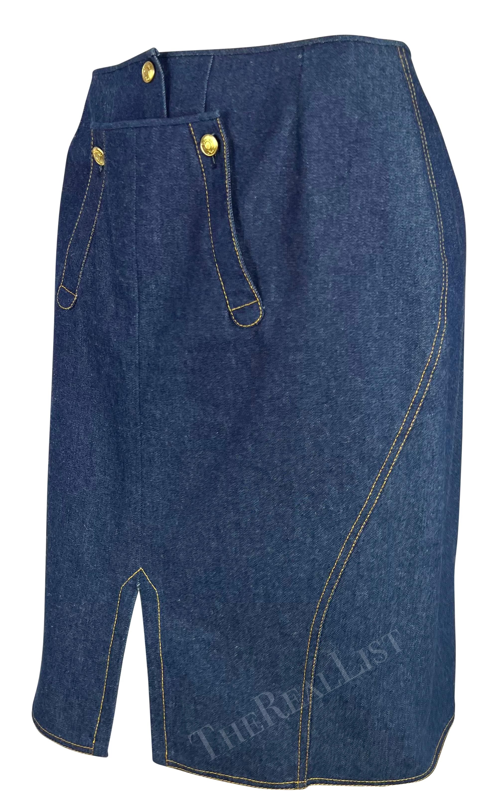 This Spring/Summer 2000 Christian Dior by John Galliano blue denim pencil skirt features a front slit, gold-tone snap buttons, and front pockets. A stylish and versatile piece, it captures Galliano’s bold take on casual wear from this iconic Dior