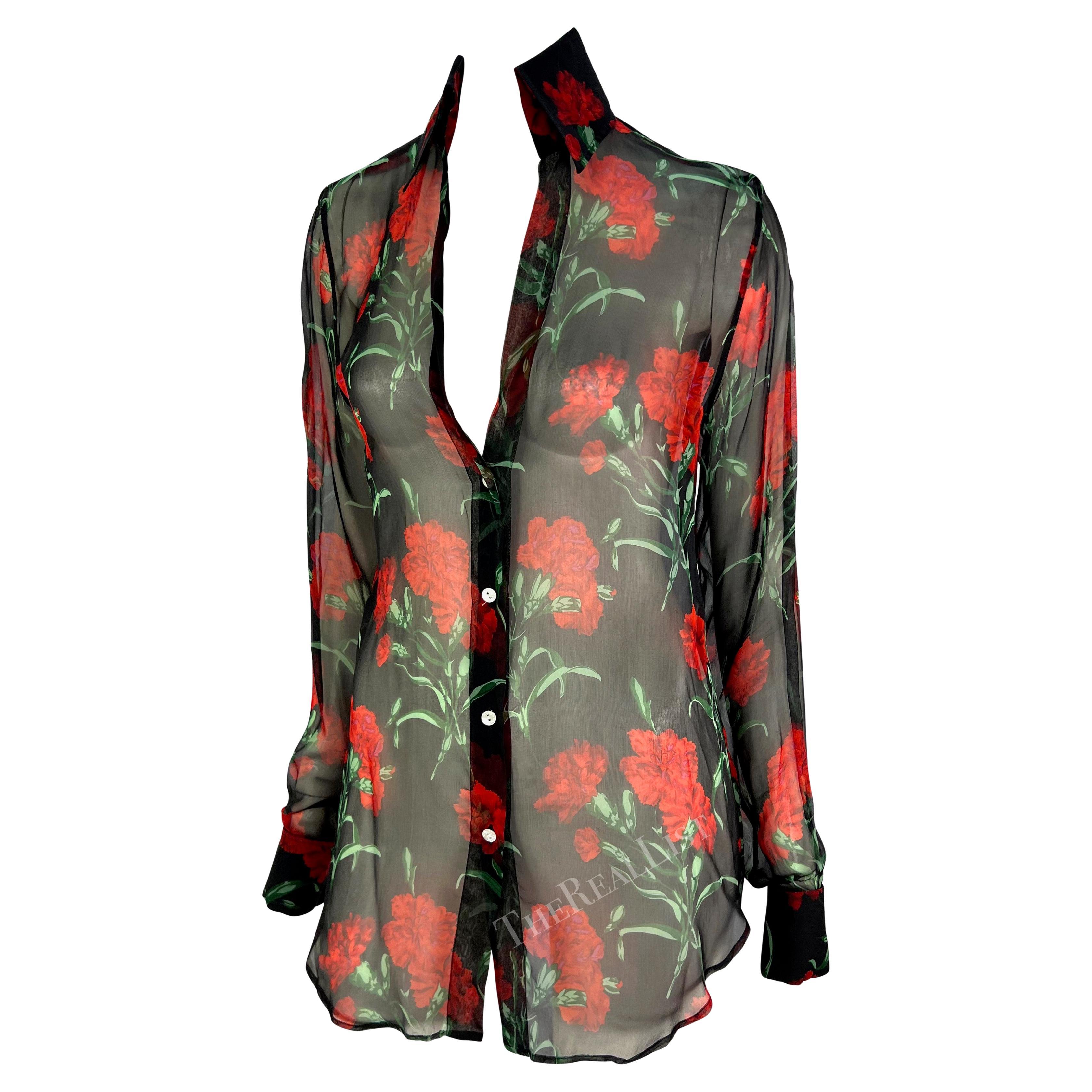 TheRealList presents: a sheer floral Dolce and Gabbana button-down shirt. From the Spring/Summer 2000 collection, this semi-sheer shirt is covered in red carnations with a black background. The top has a plunging neckline and only buttons about
