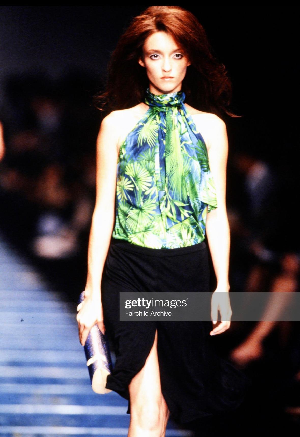 Presenting a fabulous bright green Gianni Versace skirt, designed by Donatella Versace. From the Spring/Summer 2000 collection, this vibrant green skirt features a flared cut and a light slit at the front. A black version debuted on the runway as