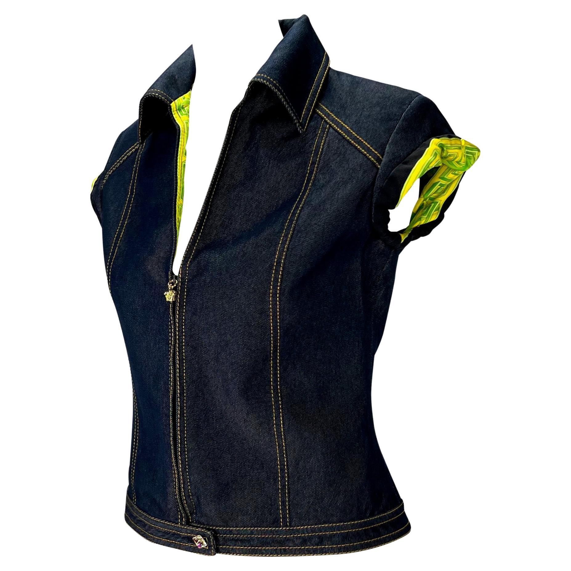 Presenting a denim zip-up Gianni Versace Couture shirt, designed by Donatella Versace. From the Spring/Summer 2000 collection, this tailored denim shirt/vest features a collar, a half-zip closure with gold Versace Medusa zipper pull, orchid jungle
