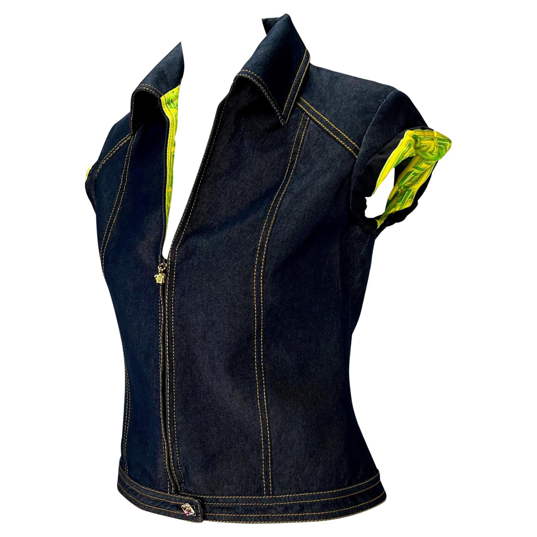 Presenting a denim zip-up Gianni Versace Couture shirt designed by Donatella Versace. From the Spring/Summer 2000 collection, this tailored denim shirt/vest features a collar, a half-zip closure with gold Versace Medusa zipper pull, orchid jungle
