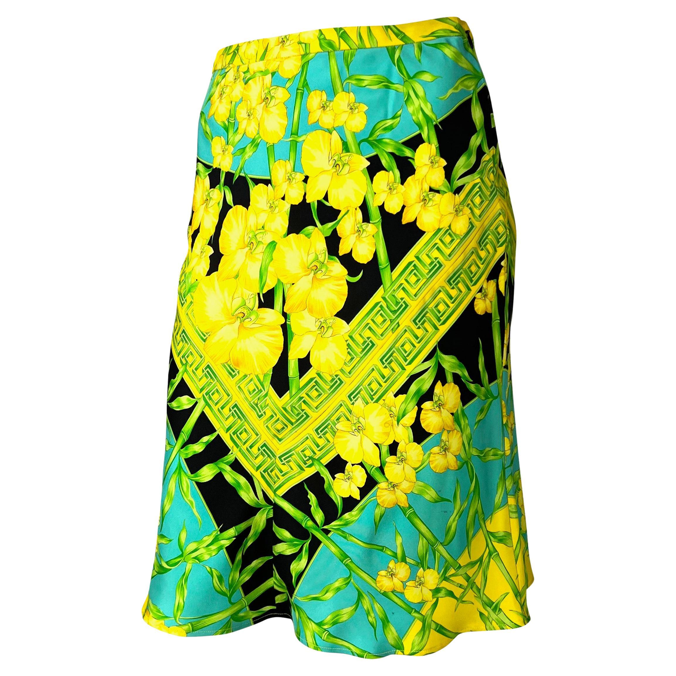 Presenting a green bamboo and yellow orchid jungle print skirt designed by Donatella for her Spring/Summer 2000 collection for the Gianni Versace label. This skirt features the bamboo print on the runway and the ad campaign in multiple variations.