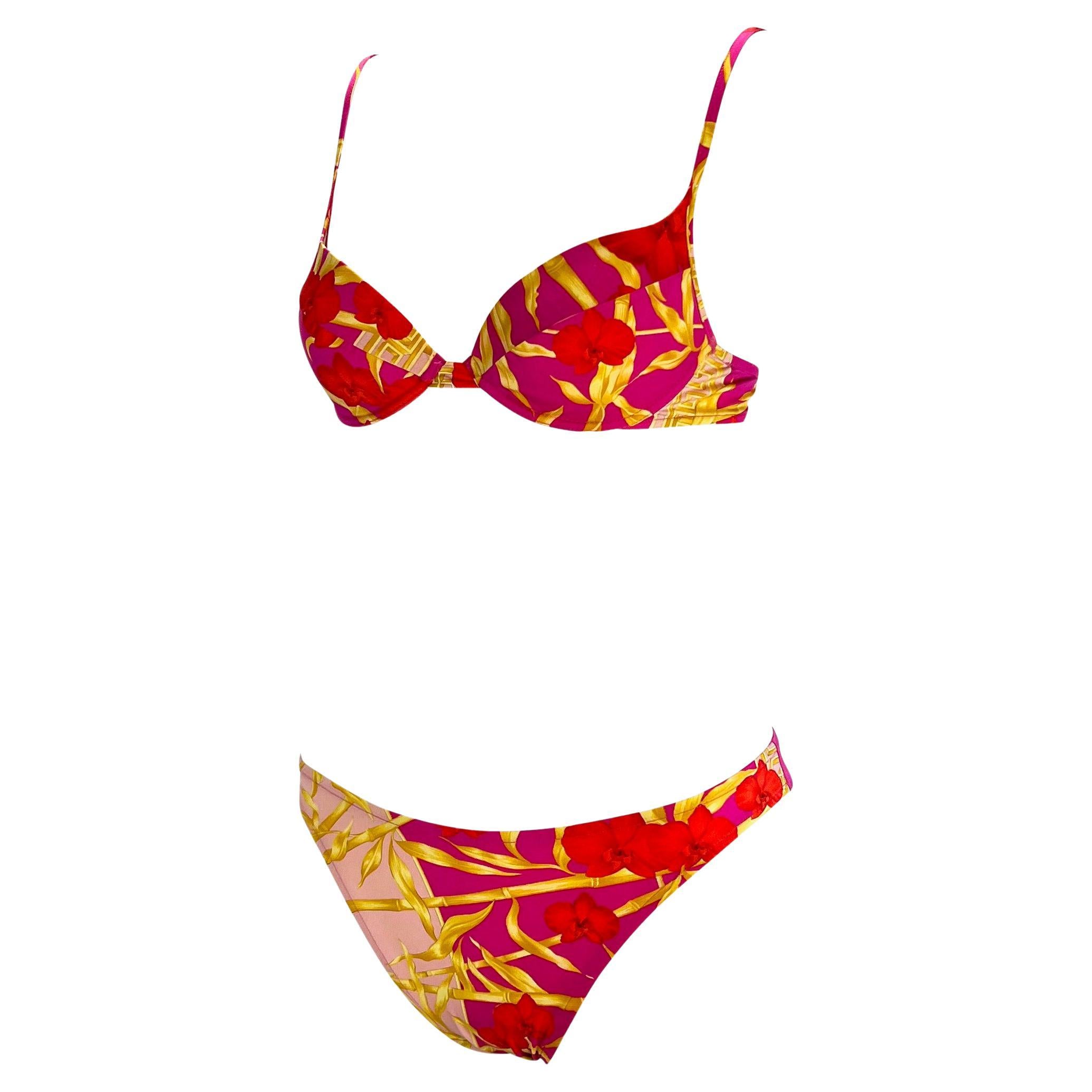 Presenting a pink orchid jungle print Gianni Versace bikini, designed by Donatella Versace. From the Spring/Summer 2000 collection, this bikini boasts a vibrant pink jungle print akin to the green one famously worn by JLo. This bikini set is