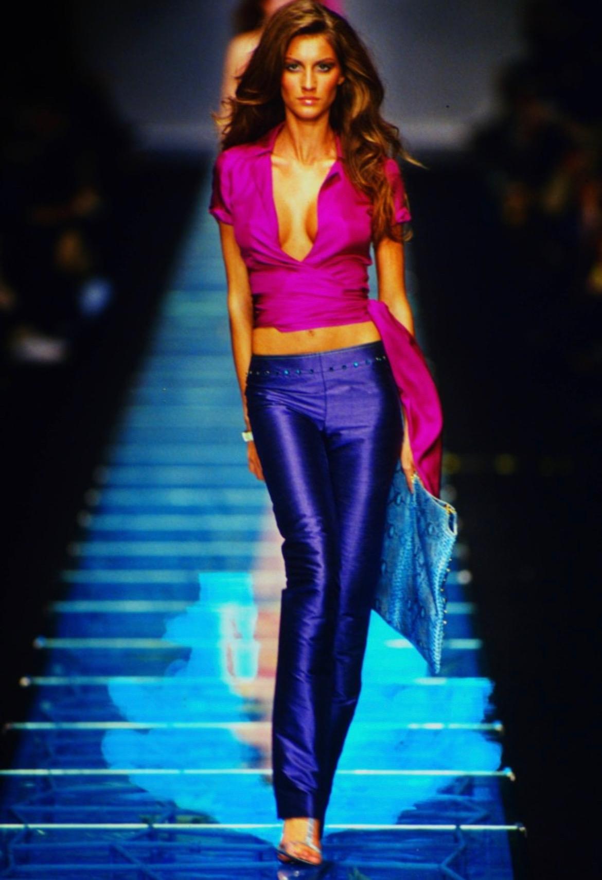 Presenting a purple silk wrap Gianni Versace Couture top, designed by Donatella Versace. From the Spring/Summer 2000 collection, this top debuted on the season's runway as part of look 30 modeled by Gisele Bündchen. The top was also worn by Amber