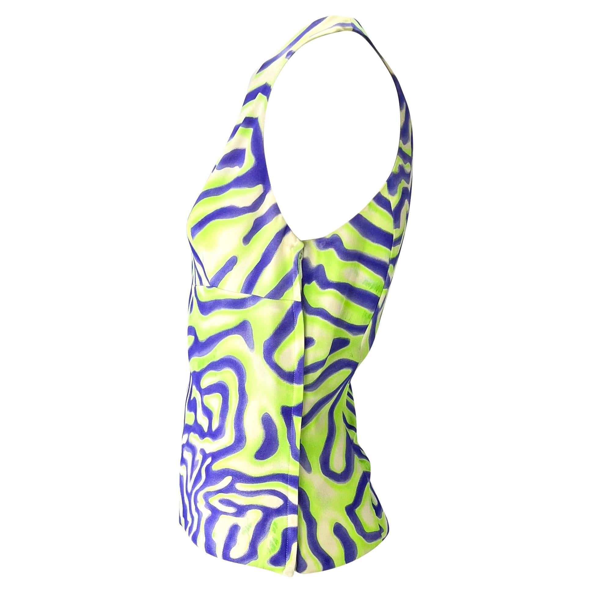 Presenting a vibrant purple and green sleeveless Gianni Versace Couture top, designed by Donatella Versace. From the Spring/Summer 2000 collection, this silk top features a deep angular neckline and is covered in an abstract tiger-like pattern. From