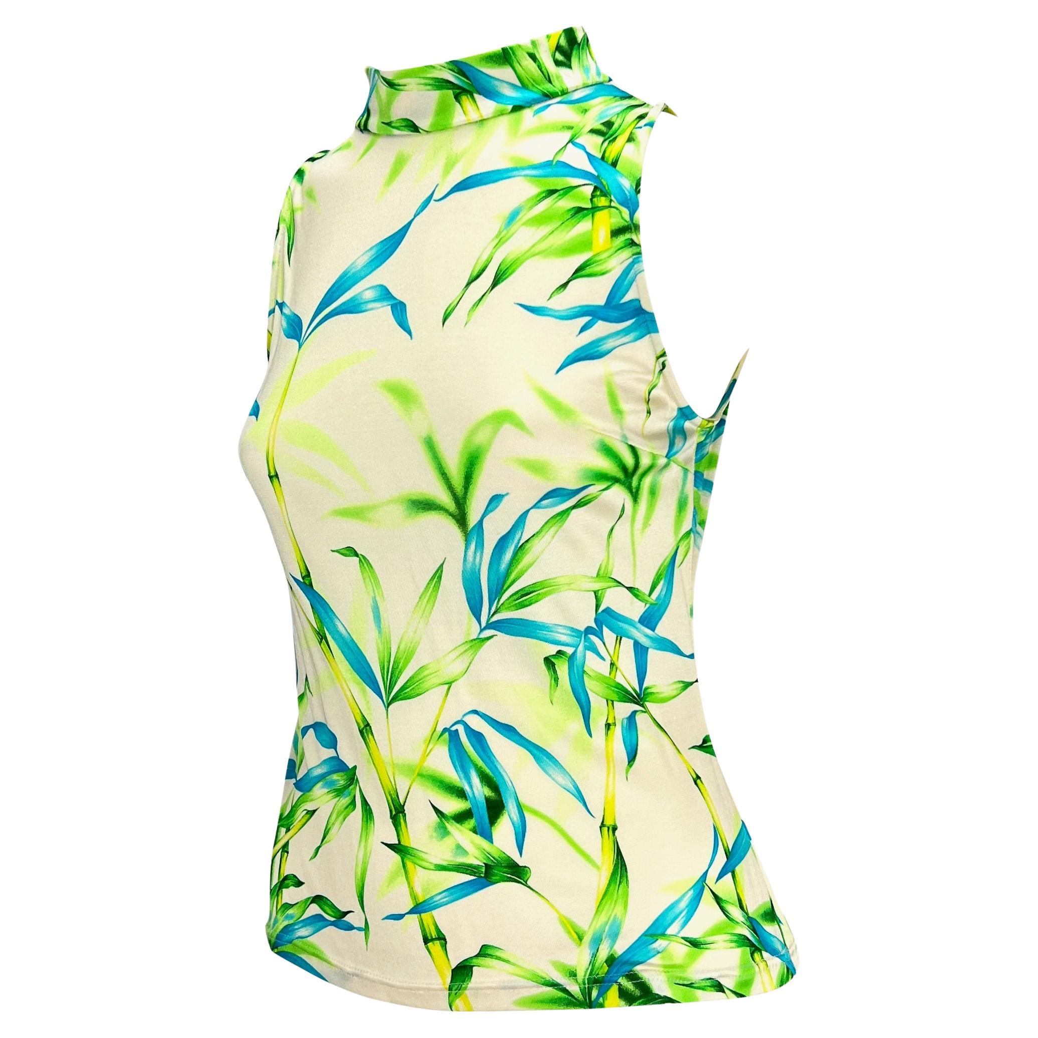 Presenting a sleeveless jungle print Gianni Versace shirt, designed by Donatella Versace. From the Spring/Summer 2000 collection, this pattern featuring green and blue neon bamboo debuted on look 14 modeled by Erin O'Connor. The top features a