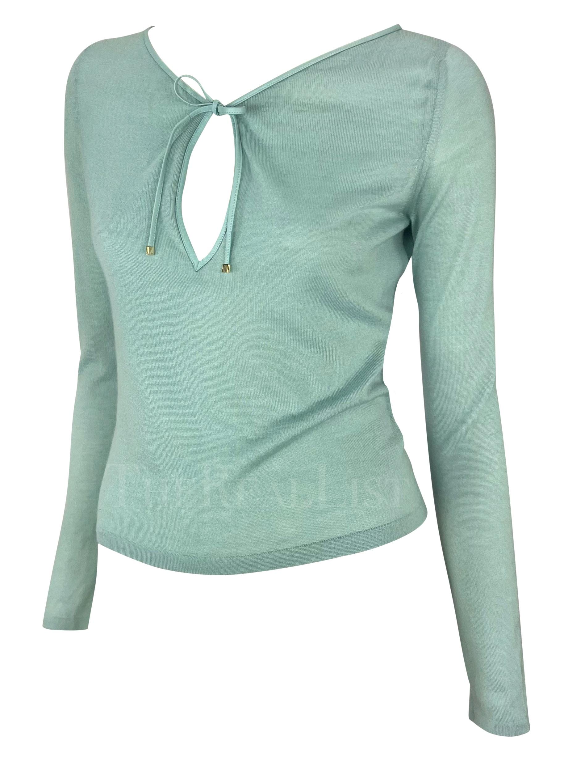 Presenting a fabulous light blue knit cashmere Gucci top, designed by Tom Ford. From the Spring/Summer 2000 collection, this top is constructed entirely of cashmere and features a leather lace detail at the neckline. The top is made complete with an