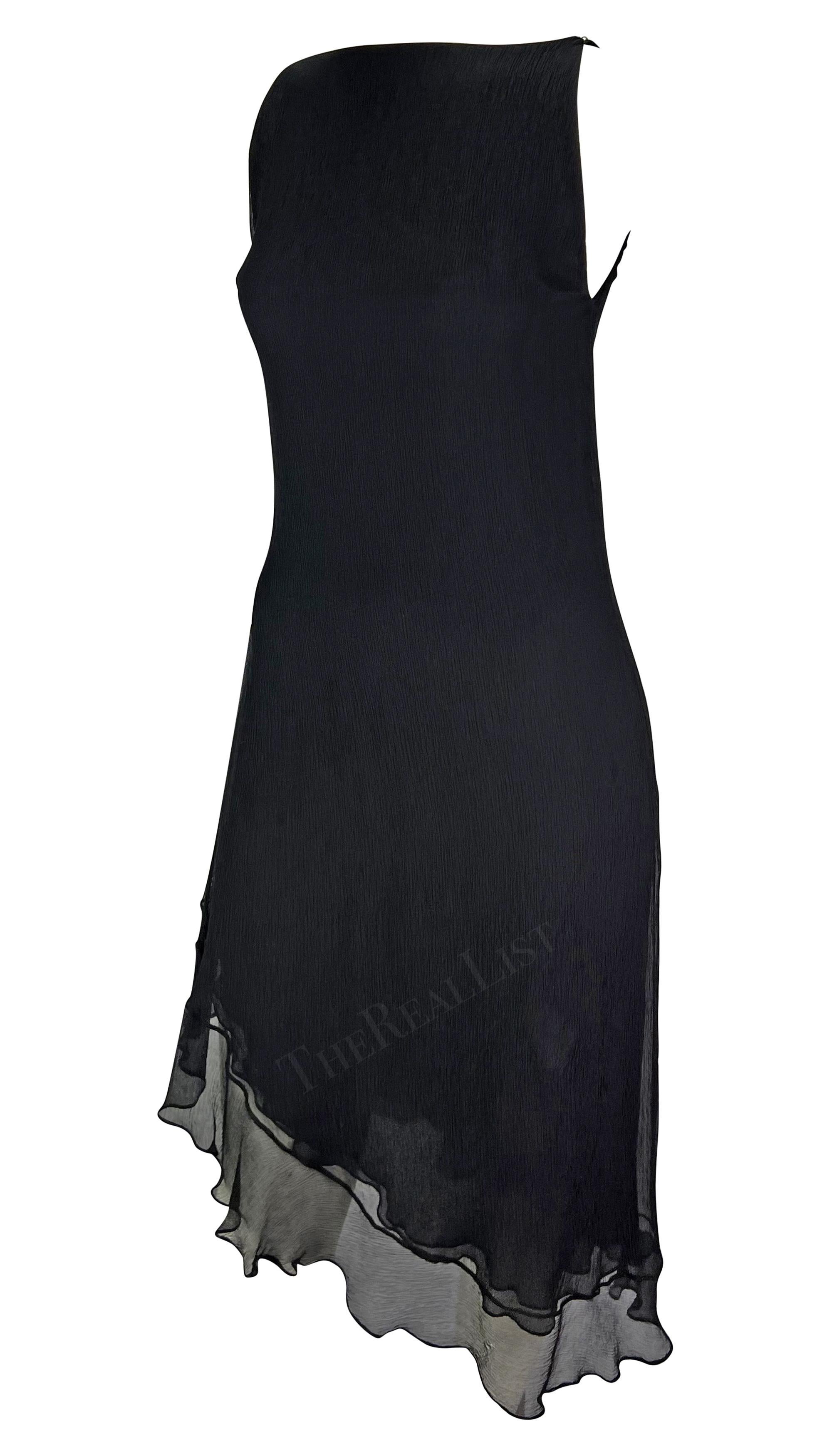 TheRealList presents: a beautiful black crepe silk Gucci dress, designed by Tom Ford. From the Spring/Summer 2000 collection, this effortlessly chic dress features a high neckline and asymmetric ruffle hem. One armhole is intentionally left larger