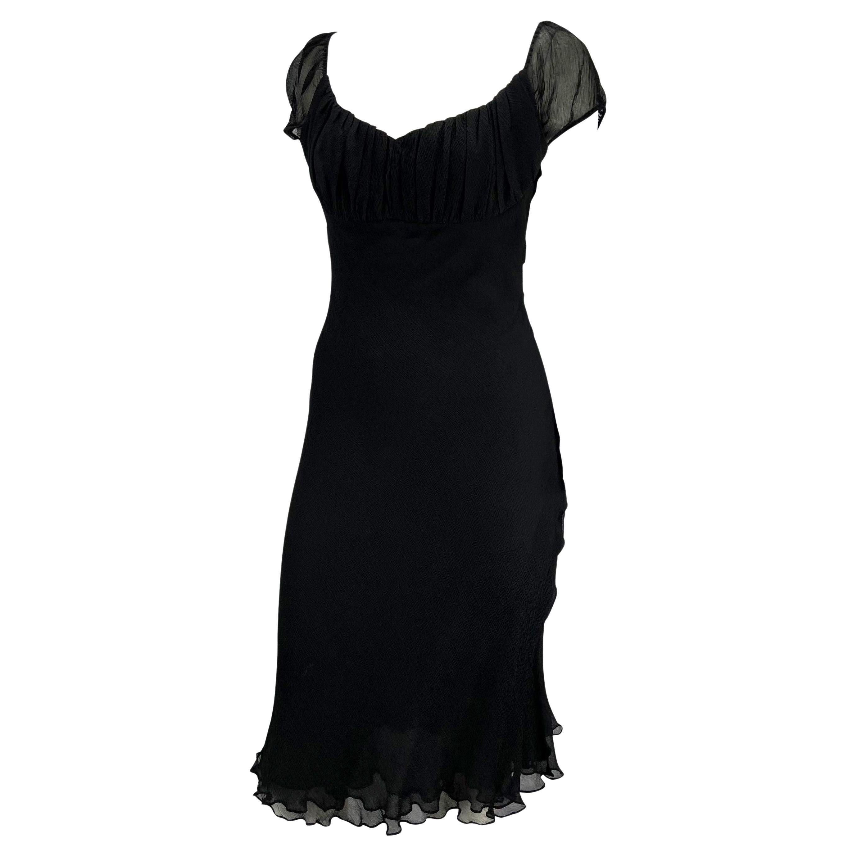 TheRealList presents: a sheer cap-sleeved cocktail dress in black crepe silk designed by Tom Ford for Gucci's Spring/Summer 2000 collection. With sheer fabric at the back and arms, the delicate black silk flows into a flirty ruffle hem. Add this