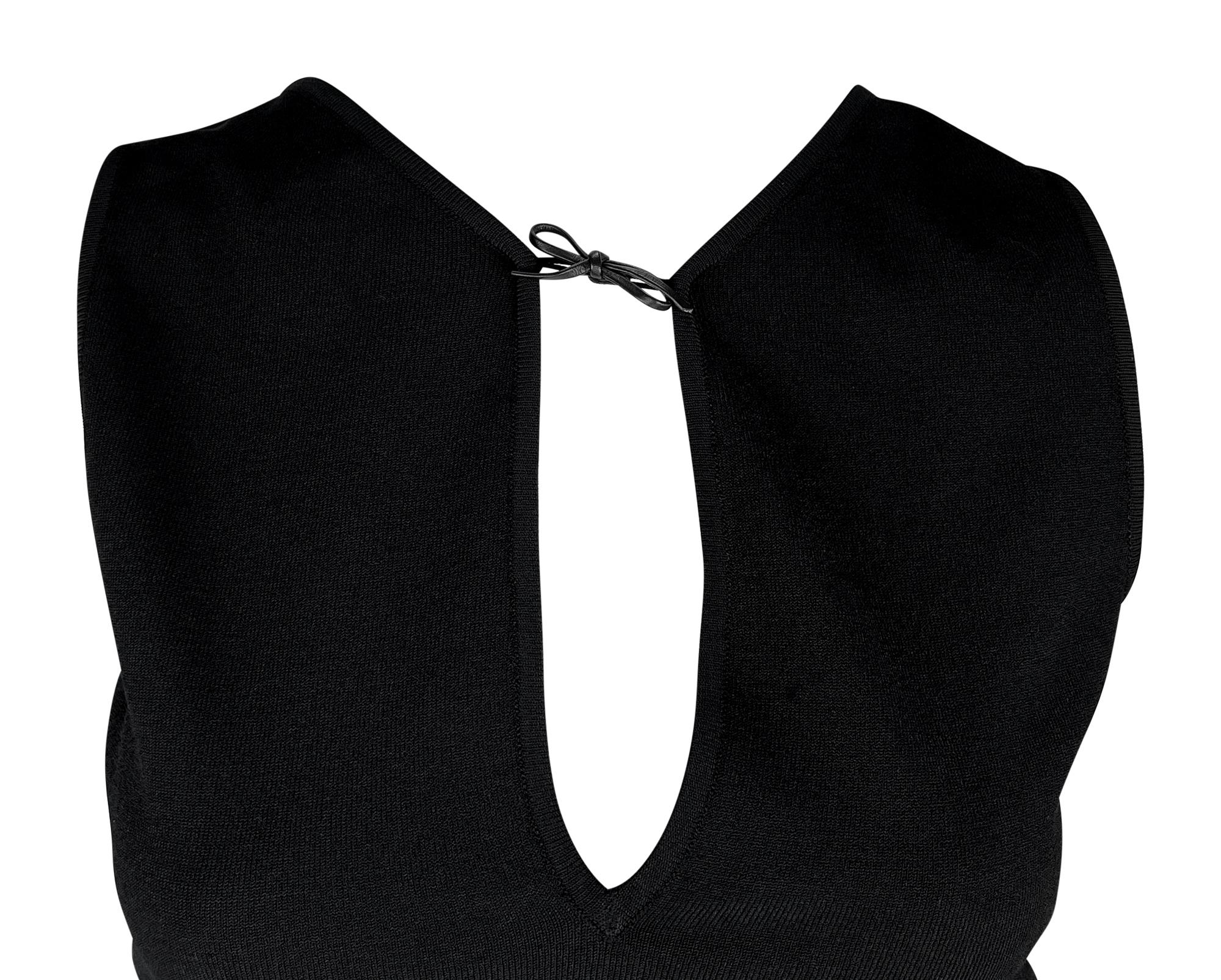 Tom Ford designed this form-fitting black stretch sleeveless top for the Gucci Spring/Summer 2000 collection. This body con top features a plunging neckline accented with a petite leather bow. 

Approximate measurements:
Size - M
Shoulder to hem: