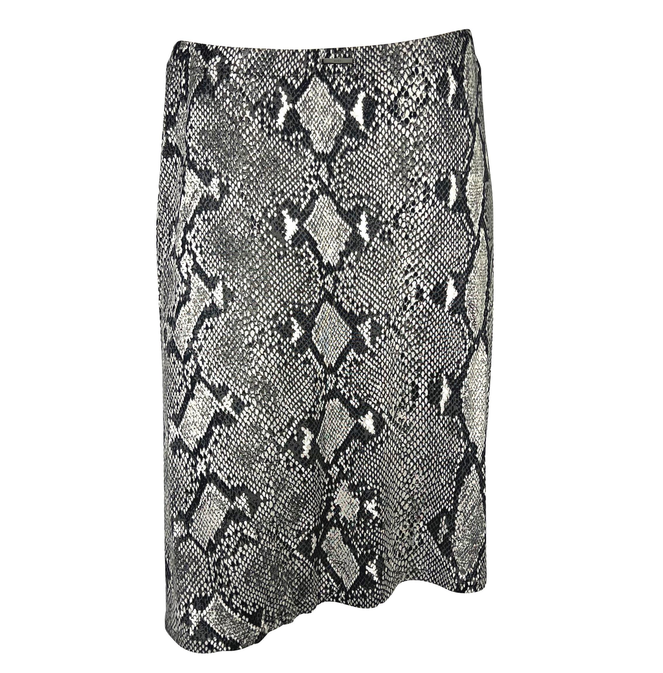 Presenting an incredible grey snakeskin Gucci skirt set, designed by Tom Ford. From the Spring/Summer 2000 collection, this snakeskin print was heavily used in Ford's collection. This set consists of a viscose t-shirt and a matching skirt. The shirt