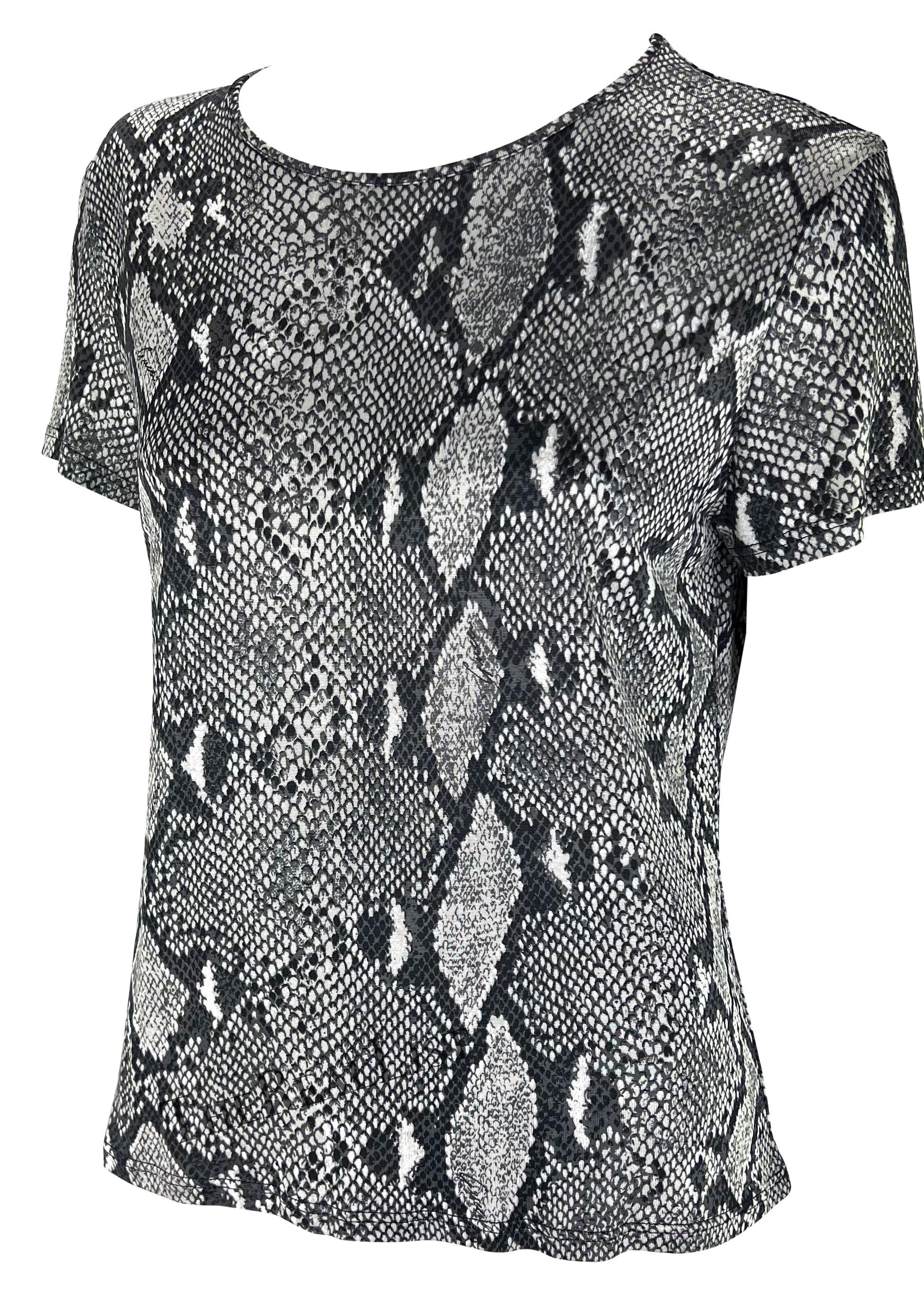 Presenting a grey snakeskin print Gucci t-shirt, designed by Tom Ford. From the Spring/Summer 2000 collection, the season's runway was covered in the identical snakeskin print as this t-shirt. This entirely viscose shirt features a wide crew