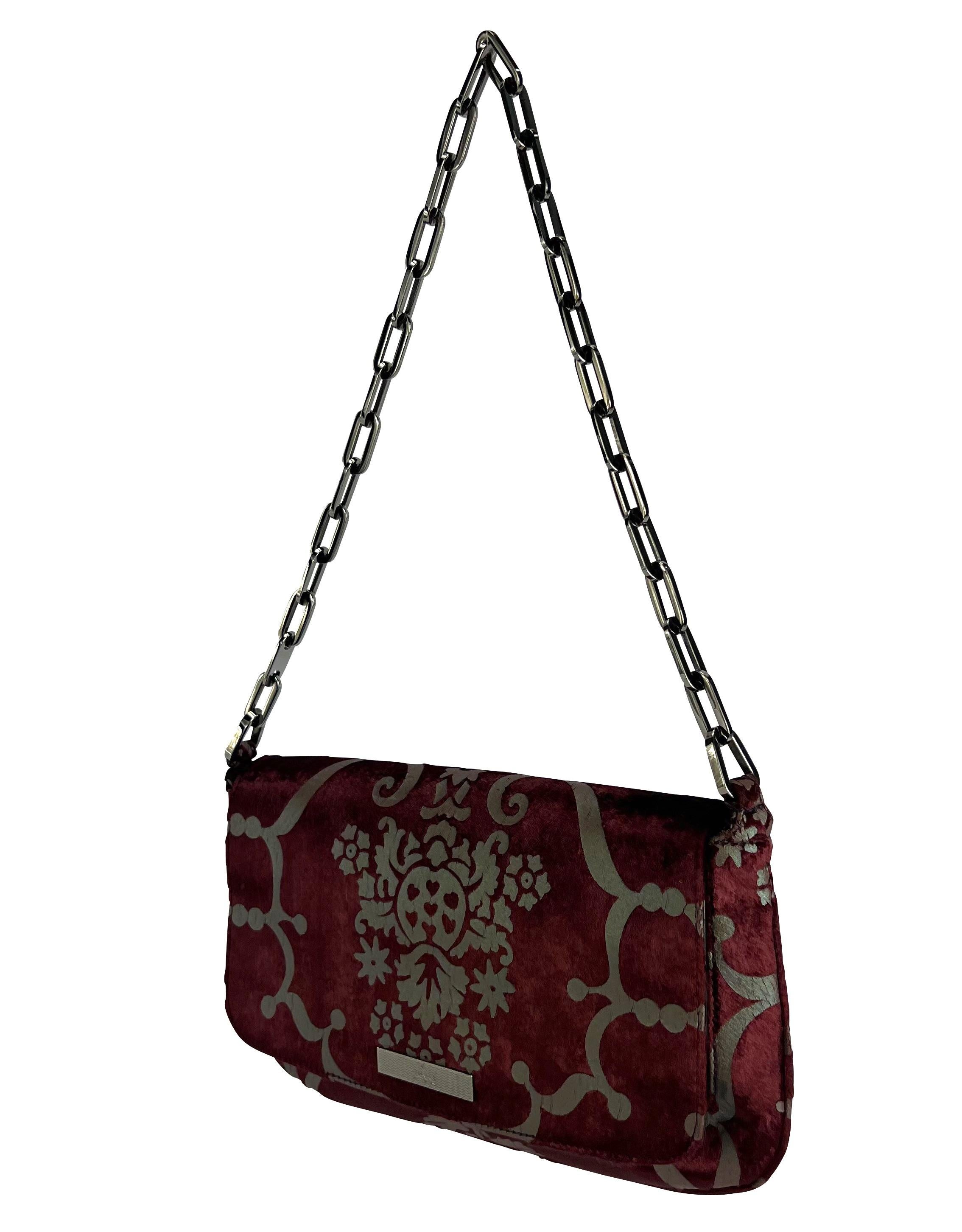 Presenting a fabulous burgundy velvet Gucci chain shoulder bag, designed by Tom Ford. From the Spring/Summer 2000 collection, this bag features a gunmetal-tone baroque pattern atop the luxurious deep red velvet. Add this timeless Gucci by Tom Ford